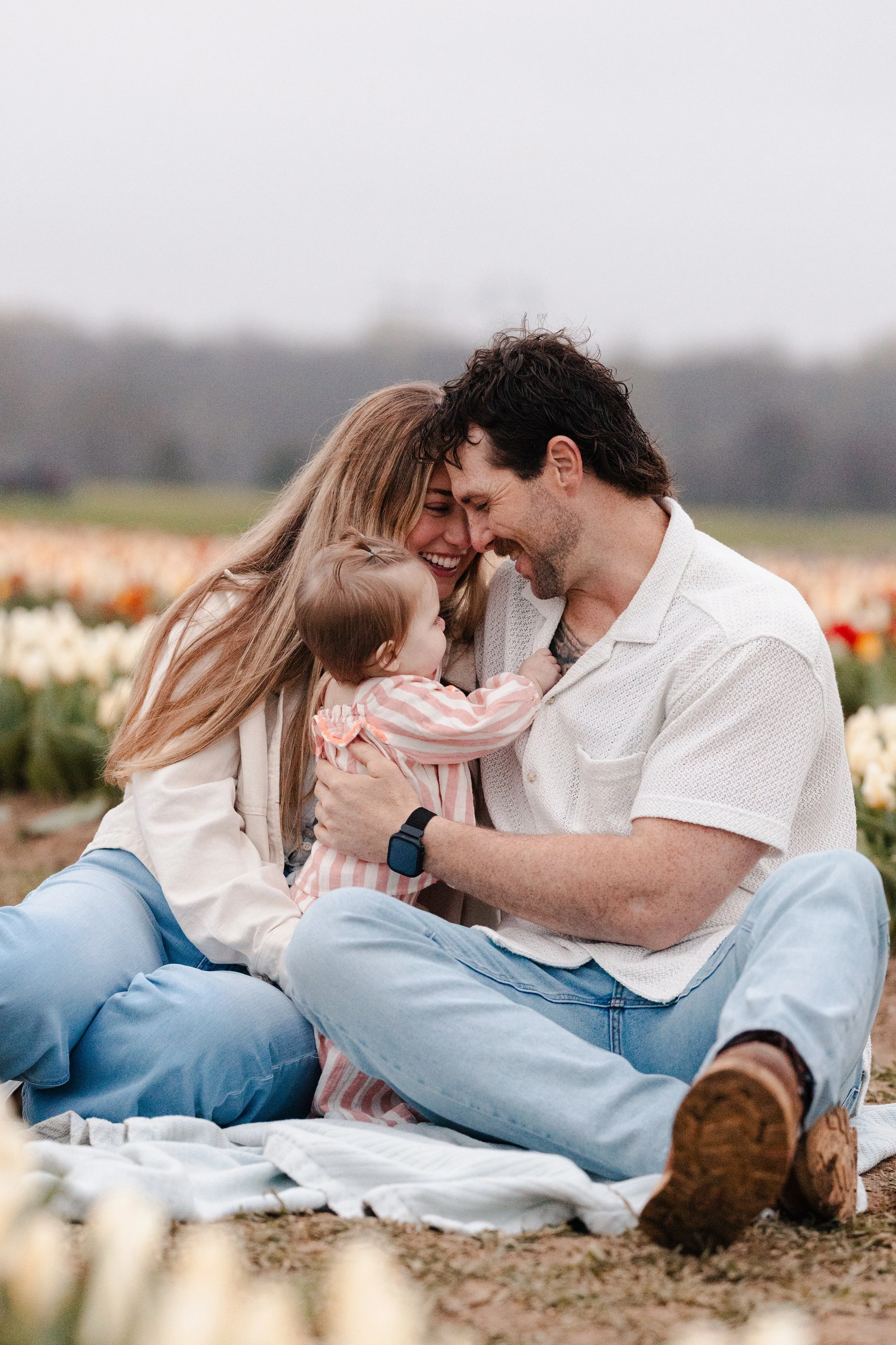 Parents holding their baby during a relaxed family photography session in Northern Virginia