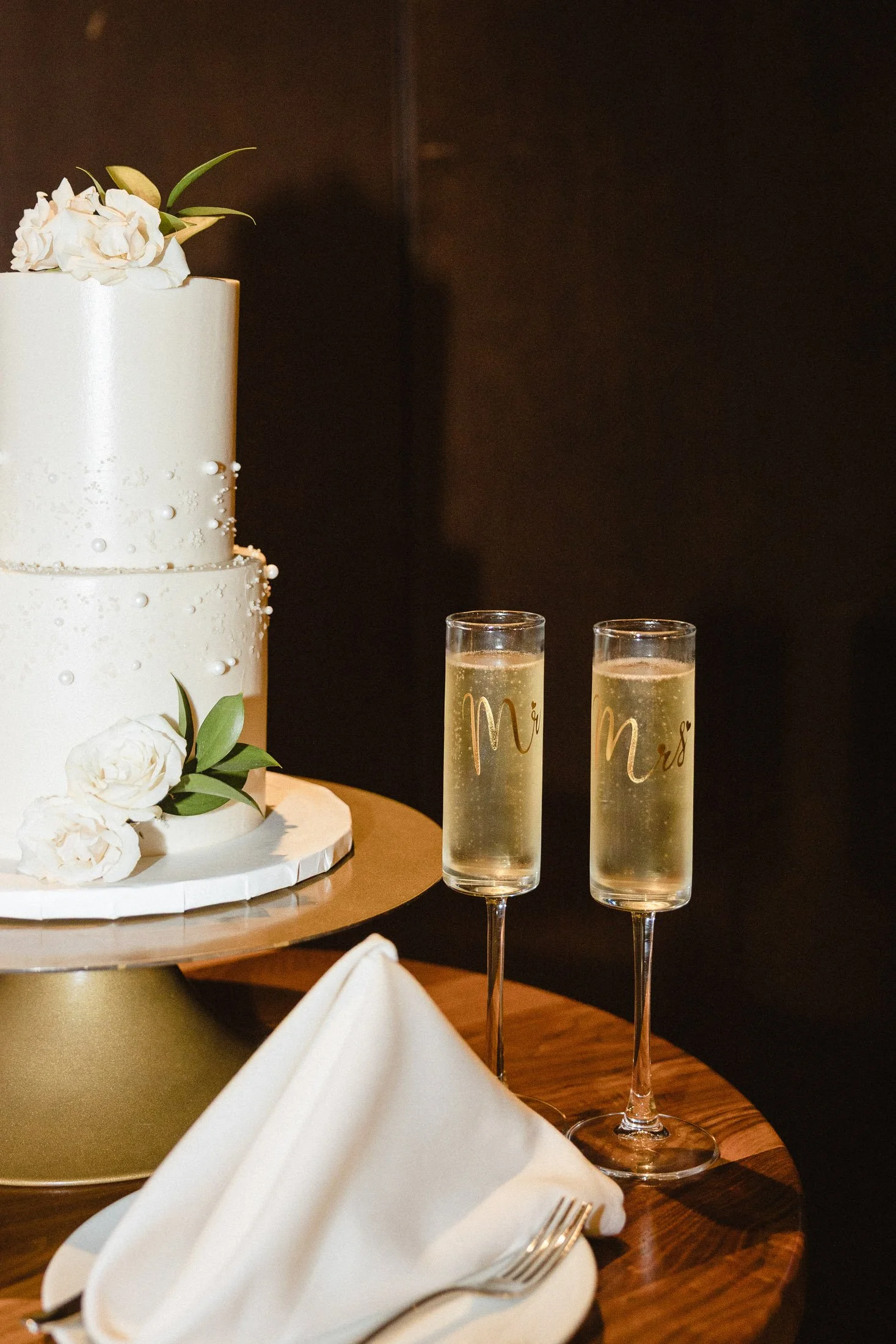 Monogramed champagne glasses and wedding cake.