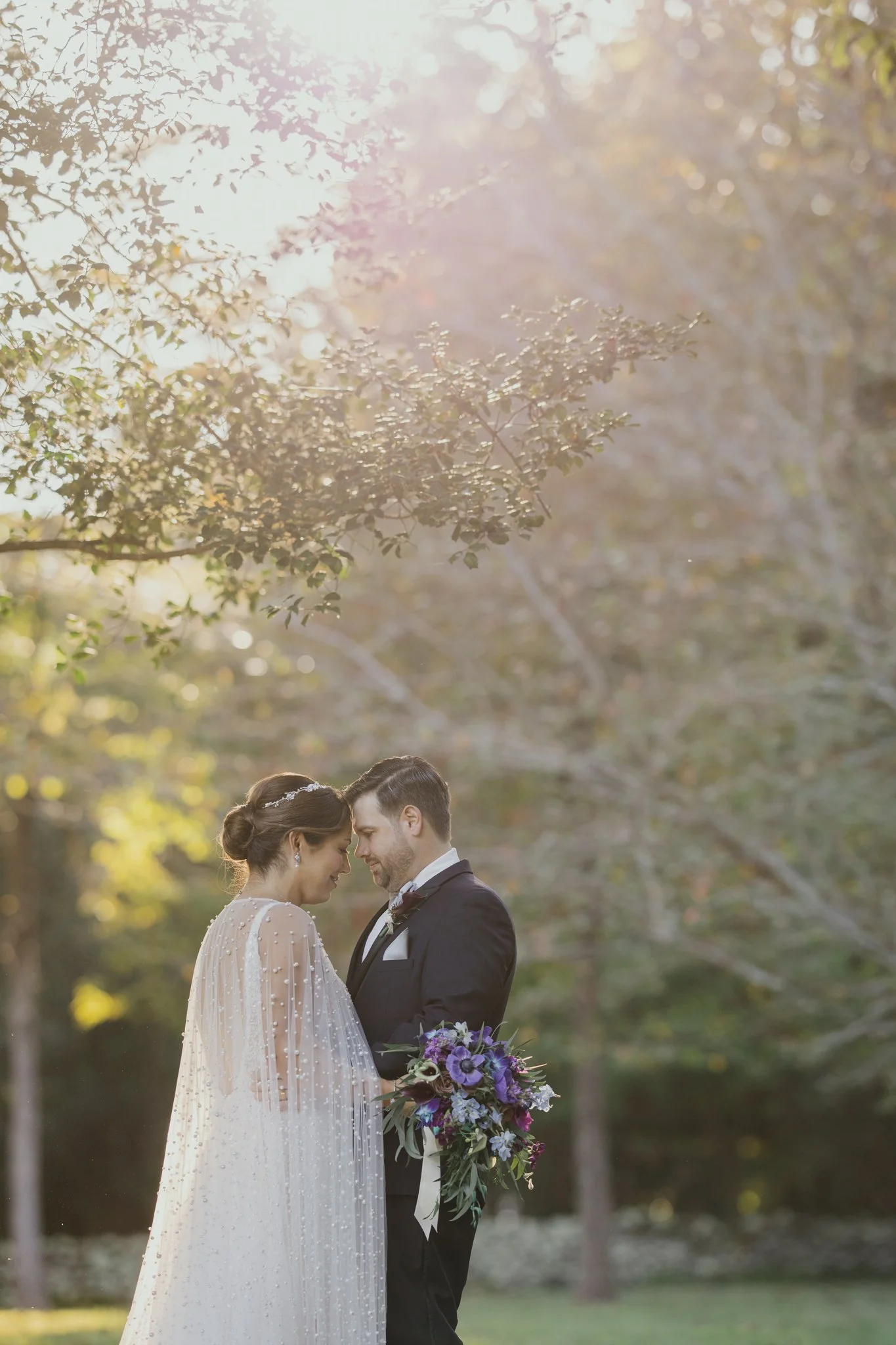 Bride and groom portrait under a tree at Airlie in Warrenton Virginia.