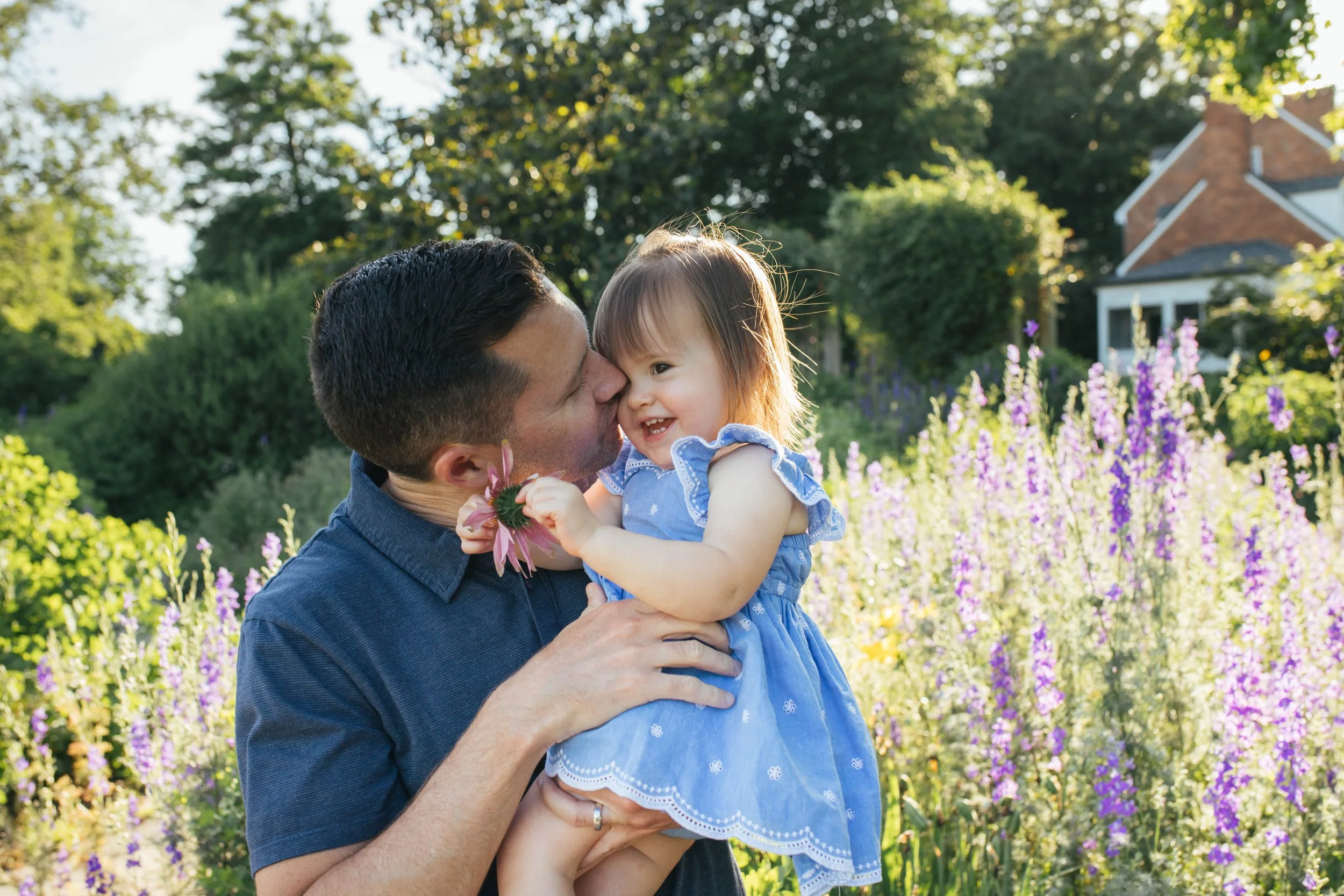 Father kissing toddler daughter among summer garden blooms at Green Spring Gardens, Alexandria Virginia — Amanda Kahnell Photography
