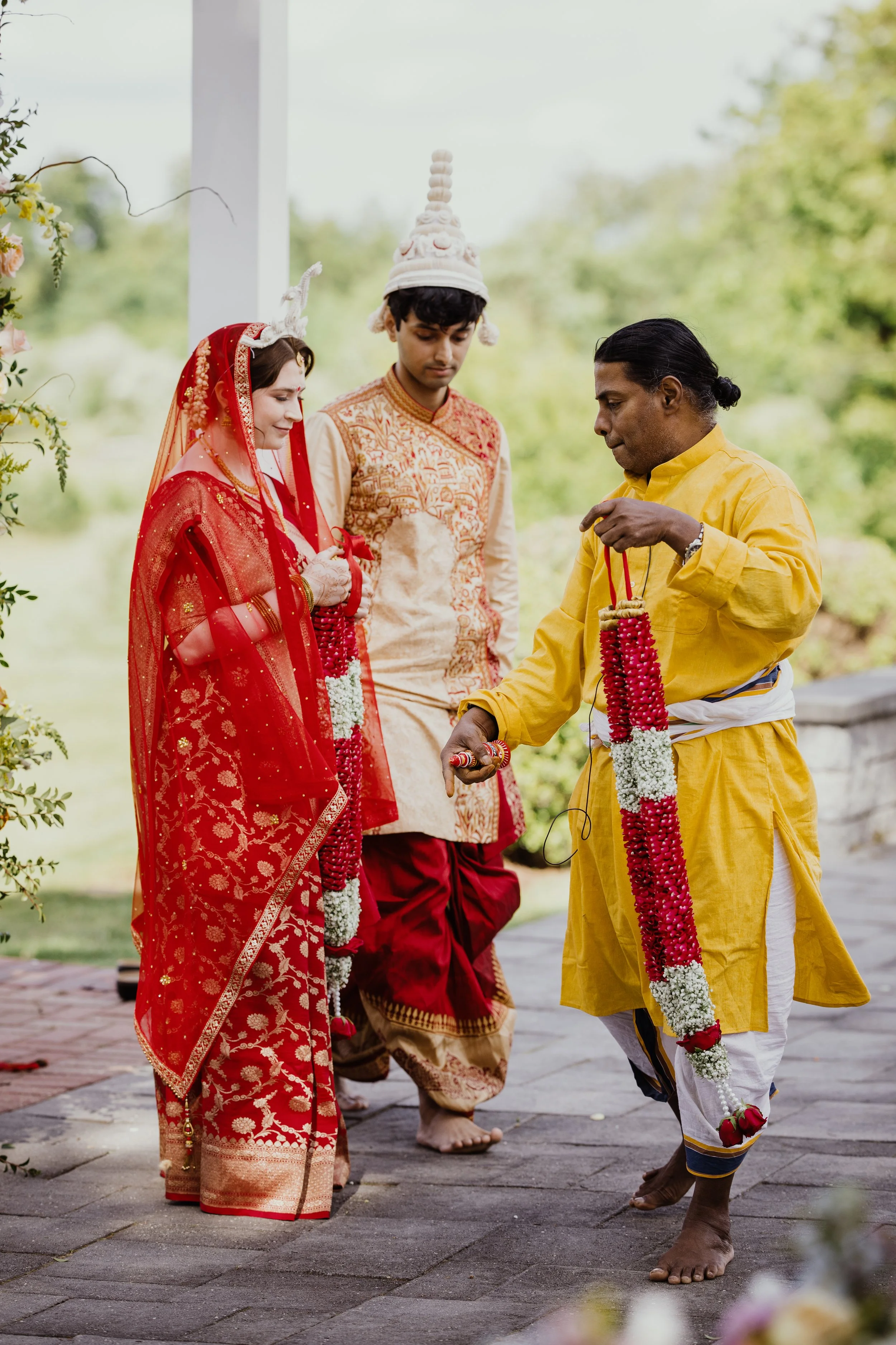 Couple participating in traditional South Asian wedding ceremony rituals outdoors in Northern Virginia.