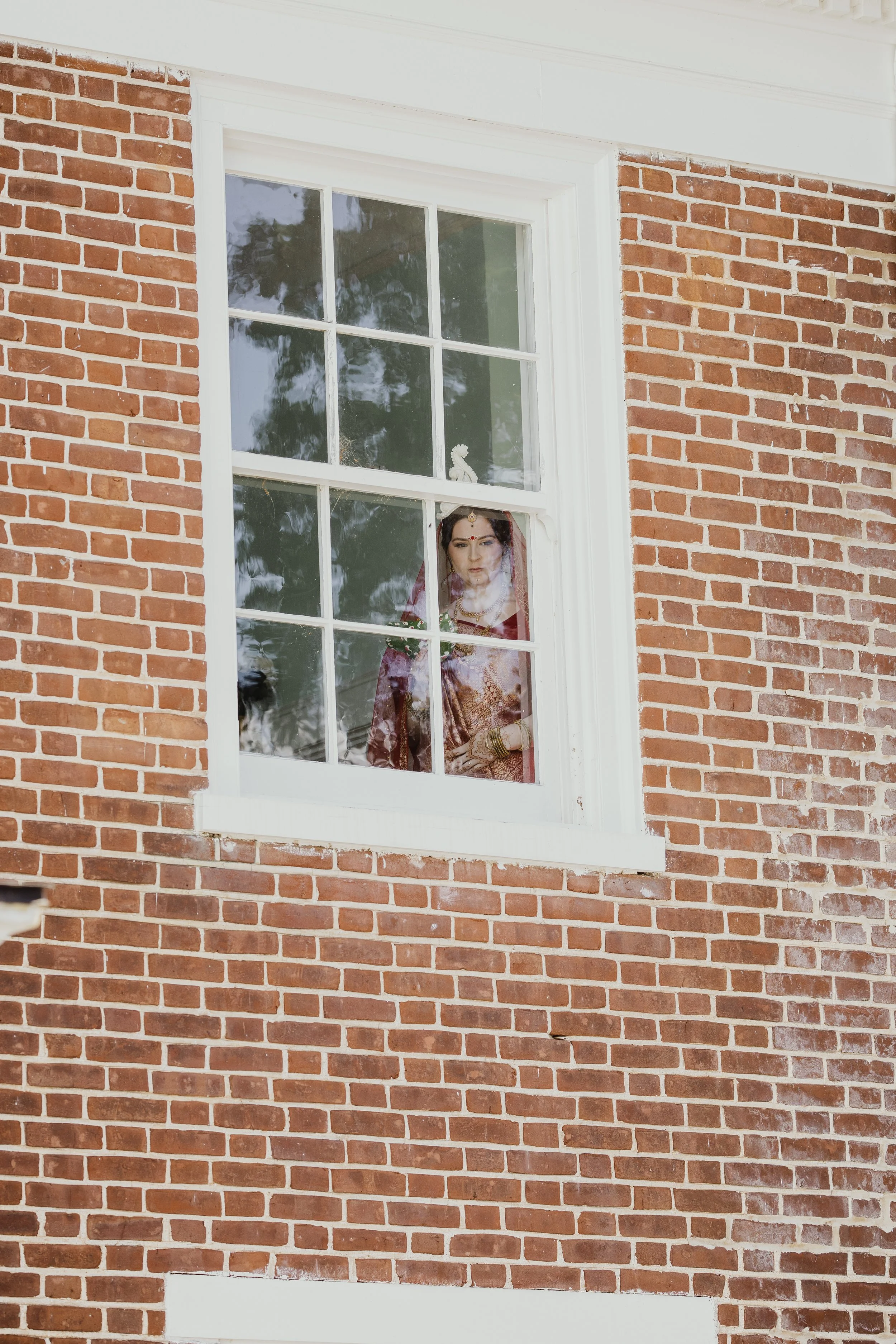 Northern Virginia Mulitcultural bride looking out window before ceremony.