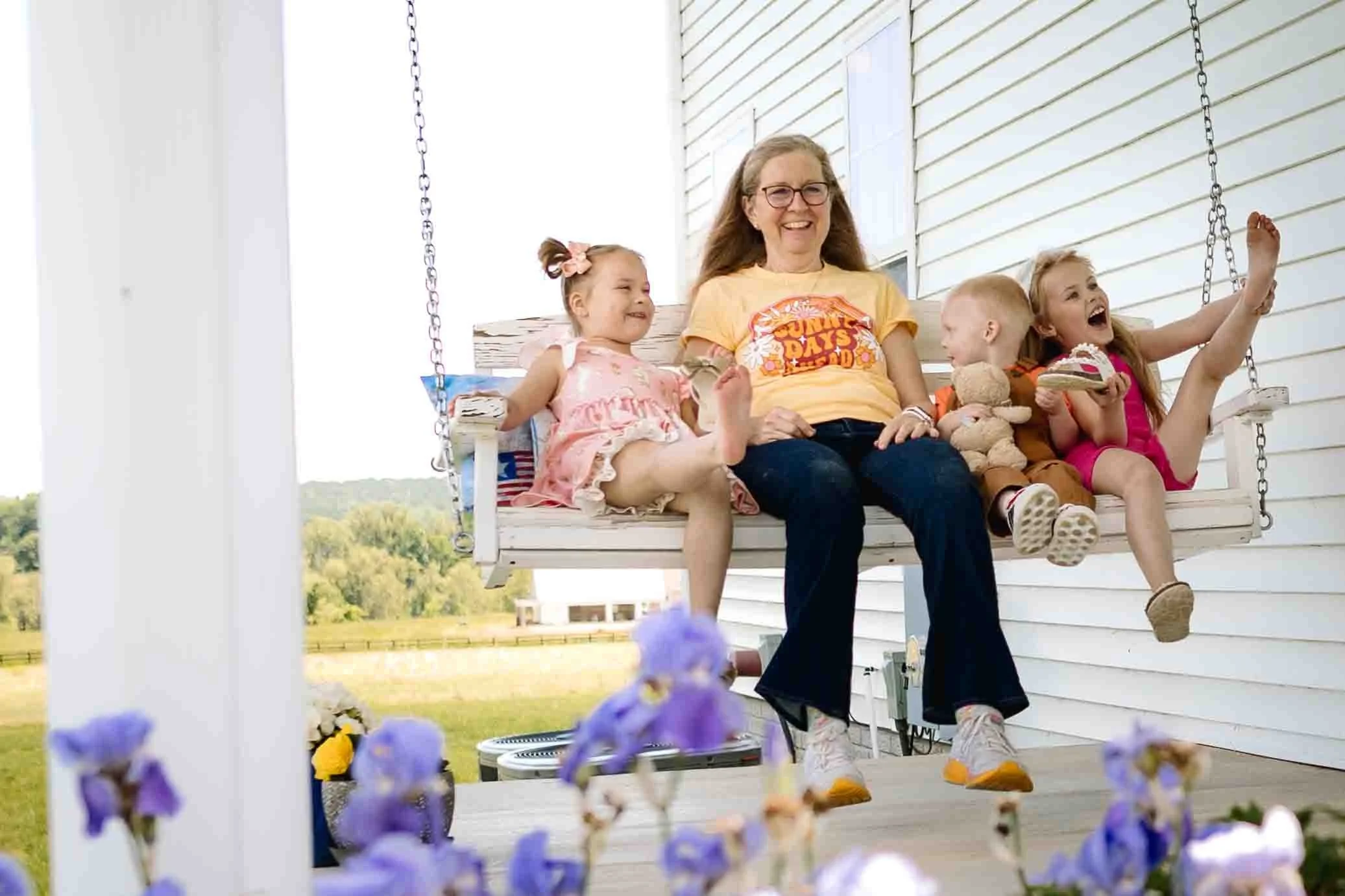 Candid documentary grandparent and grandchildren session on porch swing in Warrenton, Virginia — Amanda Kahnell Photography