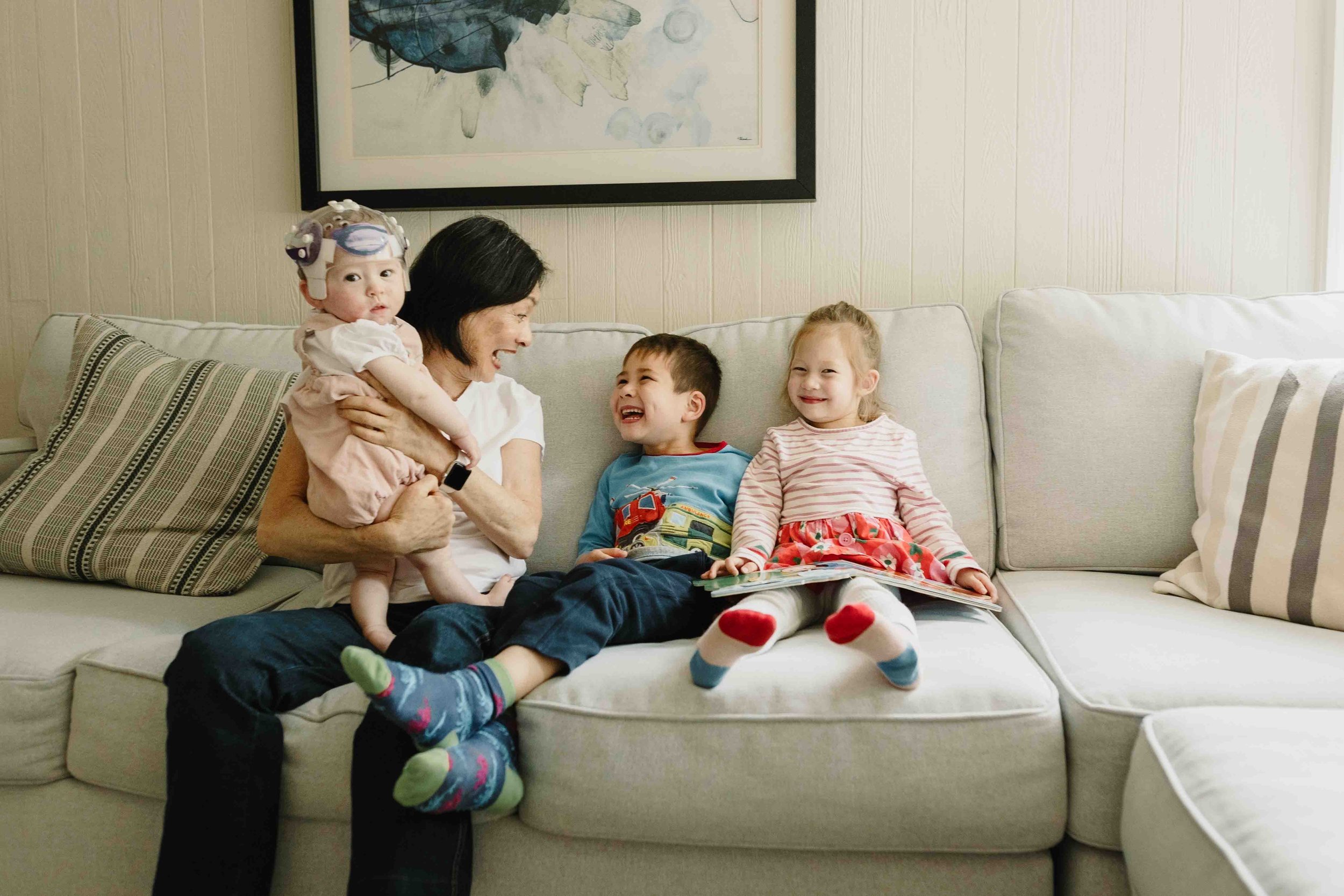 Candid in-home documentary family session in McLean, Virginia — grandmother reading with grandchildren — Amanda Kahnell Photography