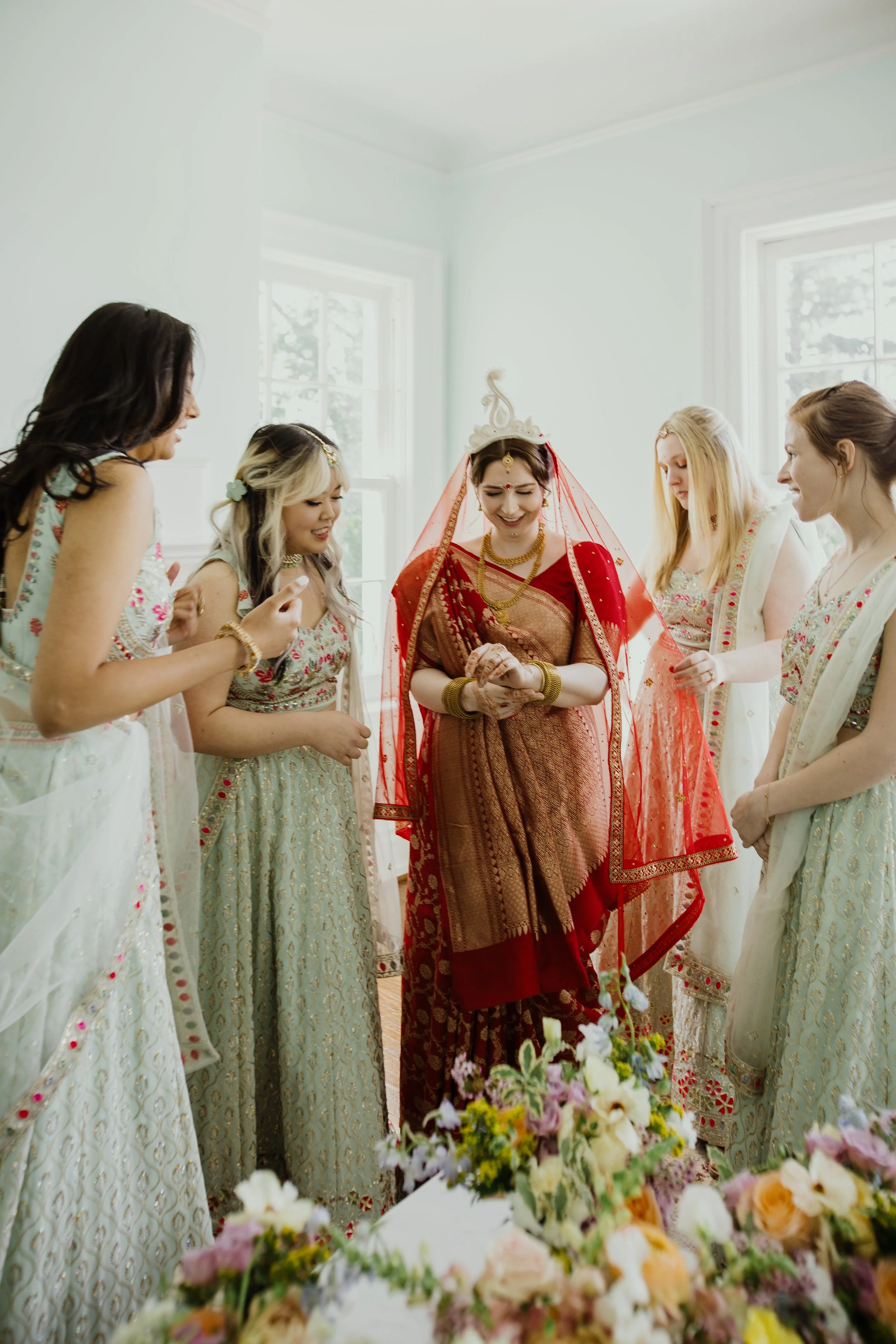 Bride sharing a quiet moment with bridesmaids during wedding preparations before a multicultural ceremony in Northern Virginia.