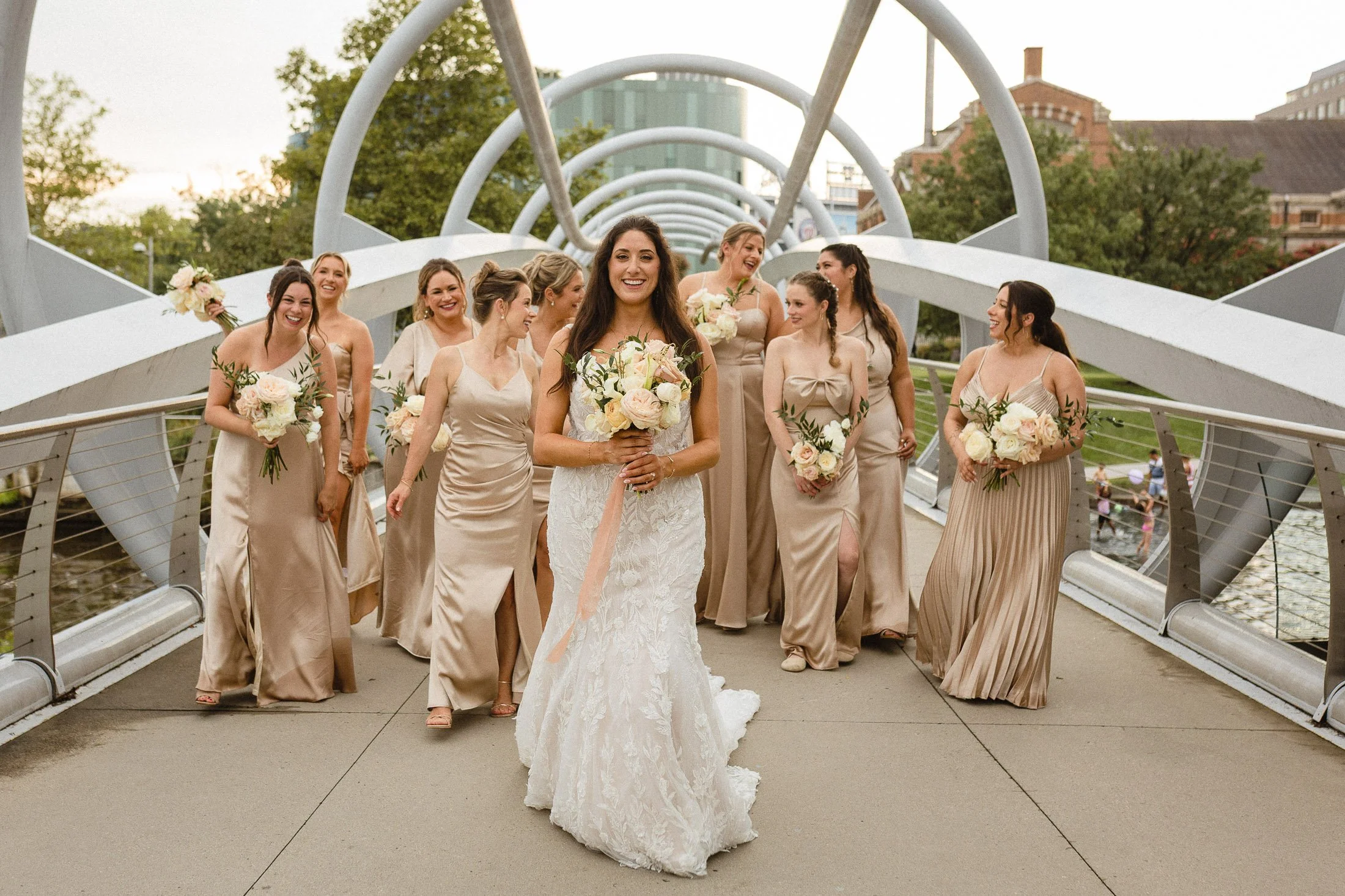 Bridesmaid and bride pose for  a candid portrait on the bridge near District Winery Washington DC