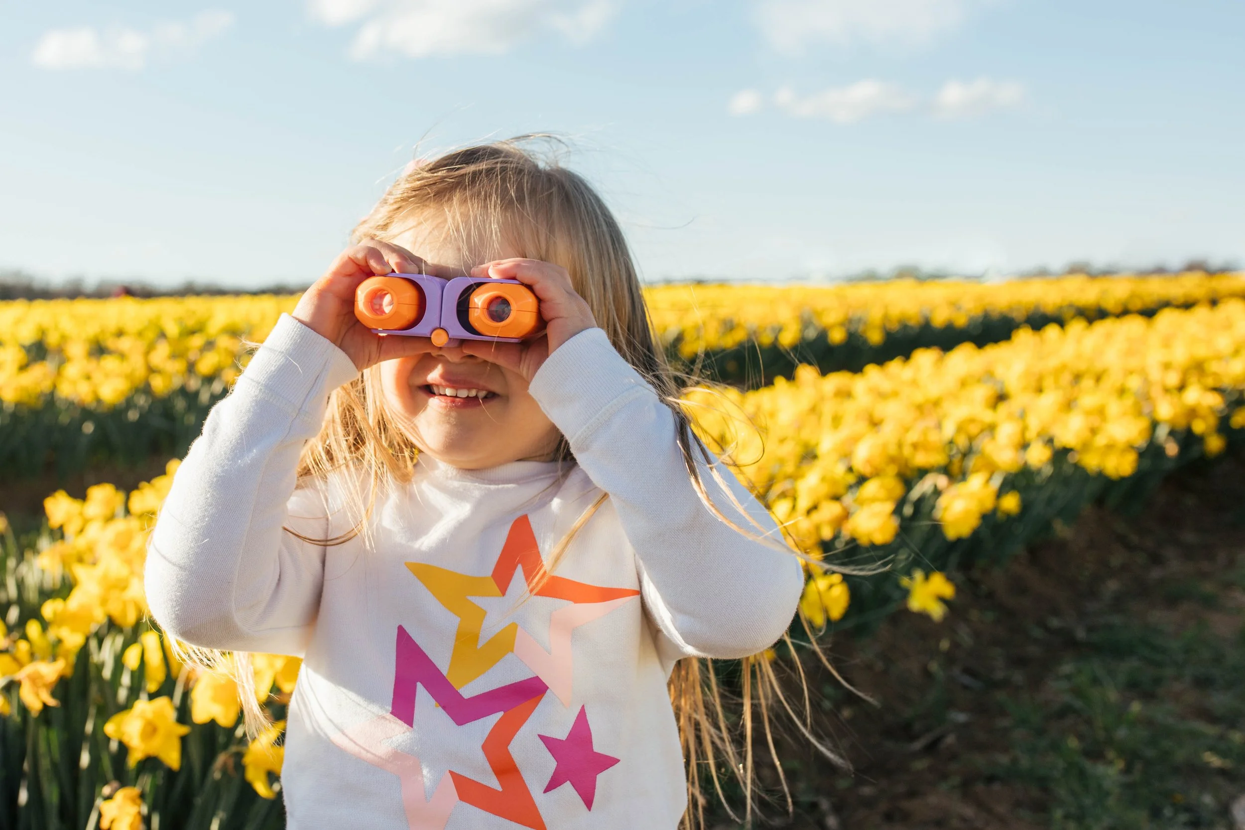 Candid child portrait in daffodil fields at Burnside Farms in Nokesville, Virginia — Amanda Kahnell Photography