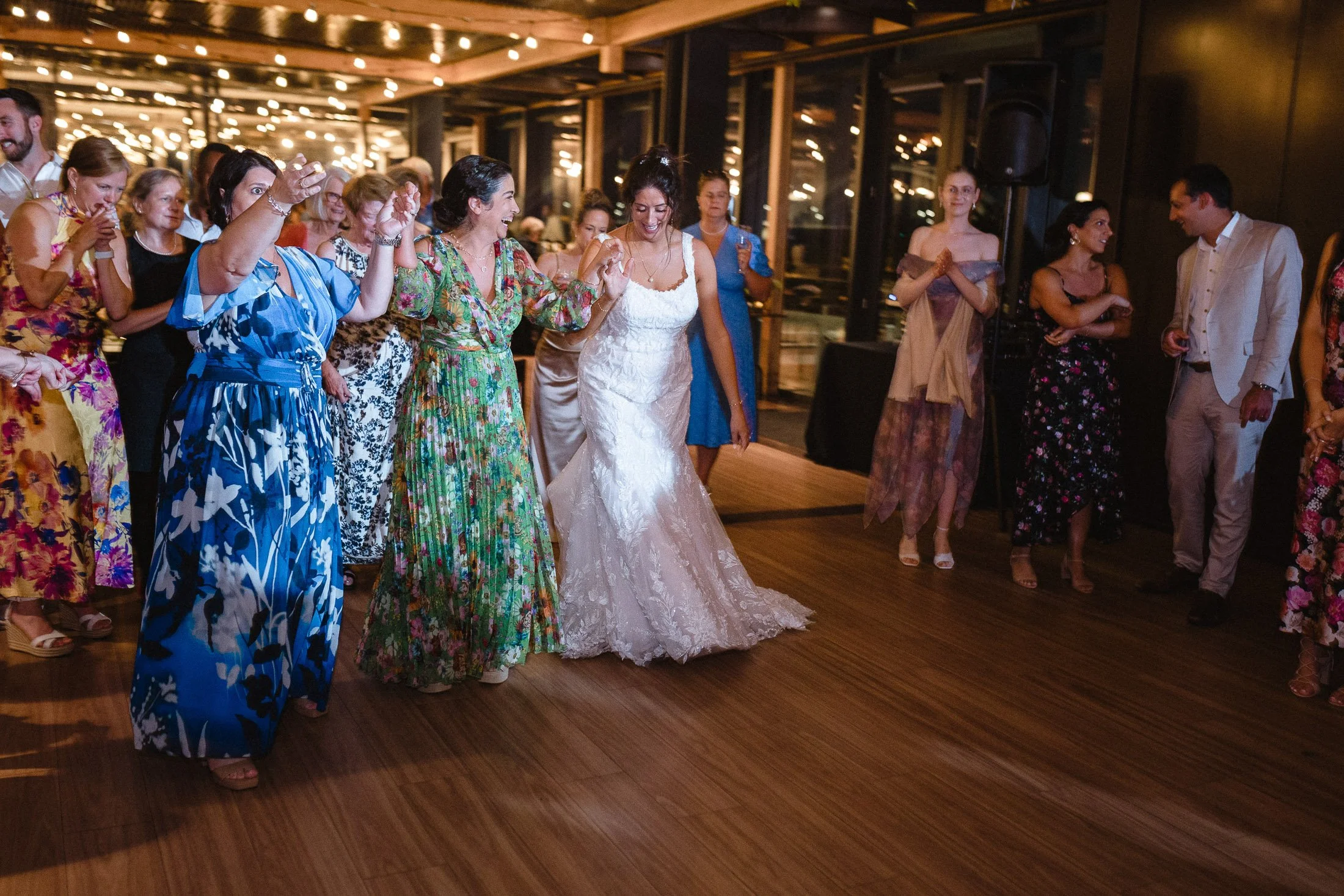Bride and wedding guests dancing a greek dance