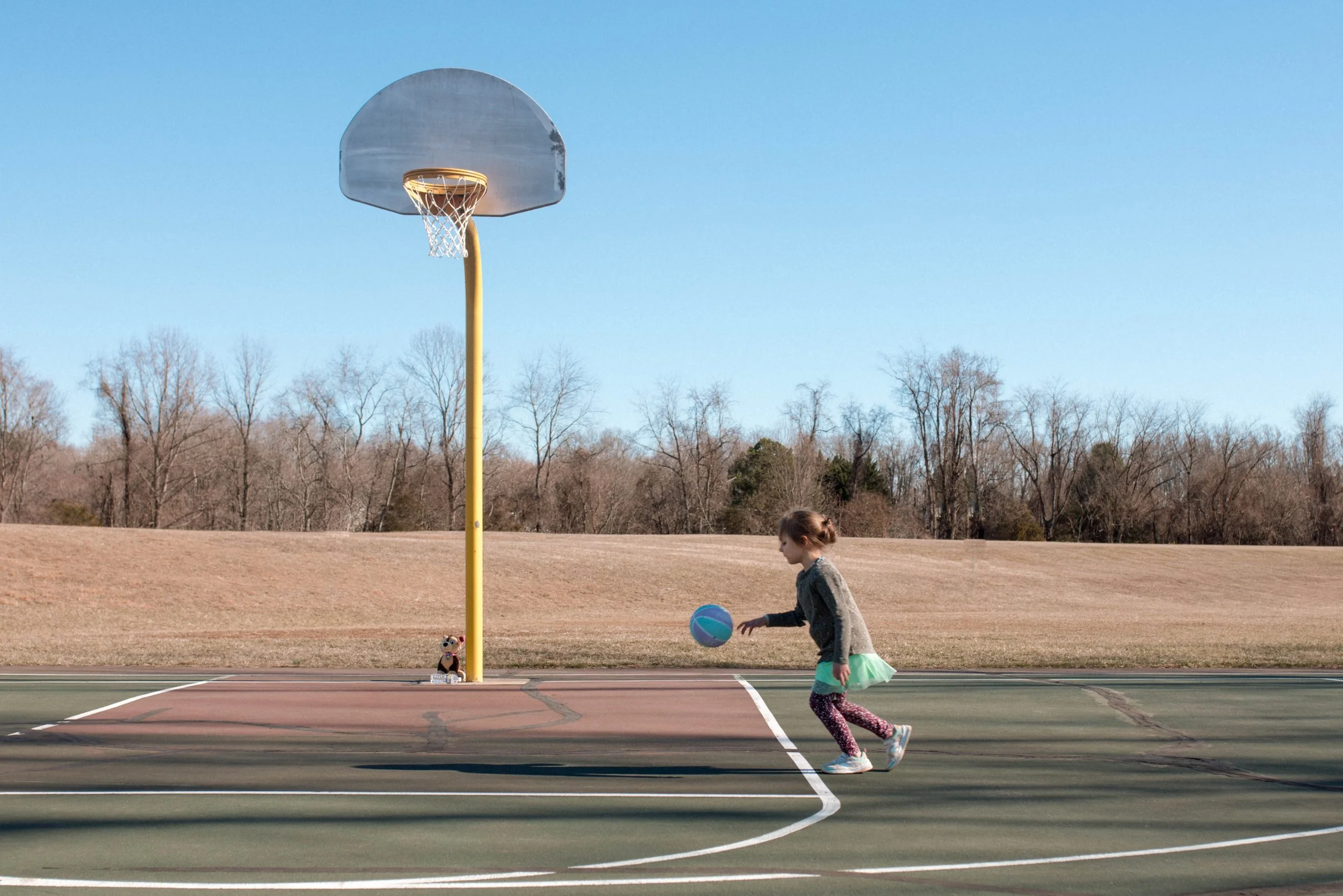 Candid documentary child playing basketball in tutu and leggings, Northern Virginia — Amanda Kahnell Photography