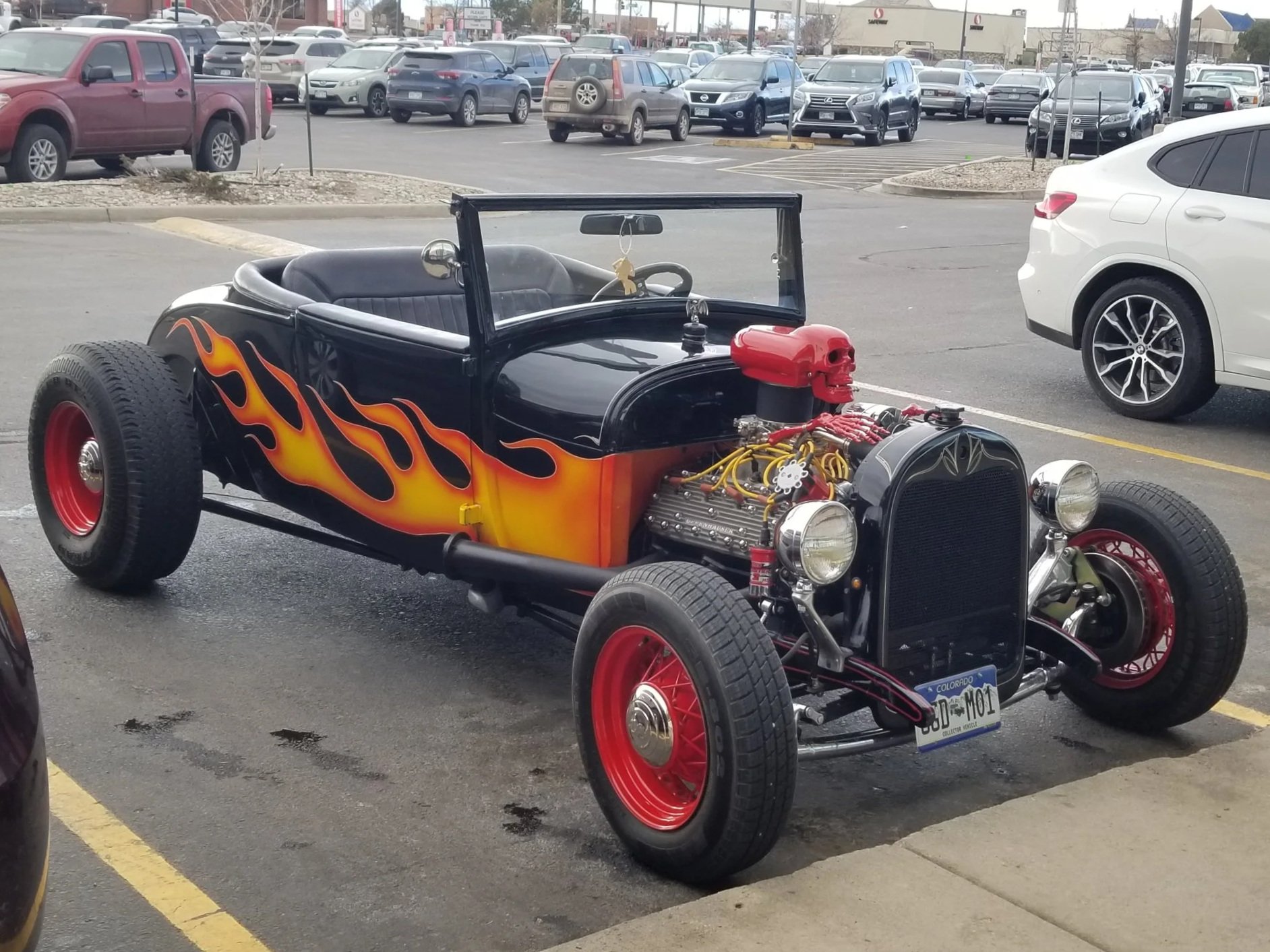 Vintage hot rod with flame paint parked in lot