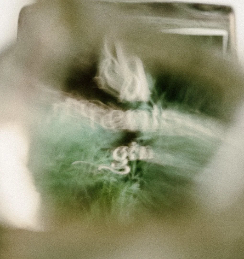 Blurred and abstracted image of a person adjusting a computer or device, with green and white tones dominating