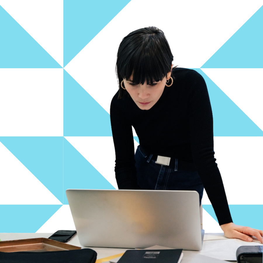 Plastic surgery practice manager reviewing workflows and team performance on laptop.