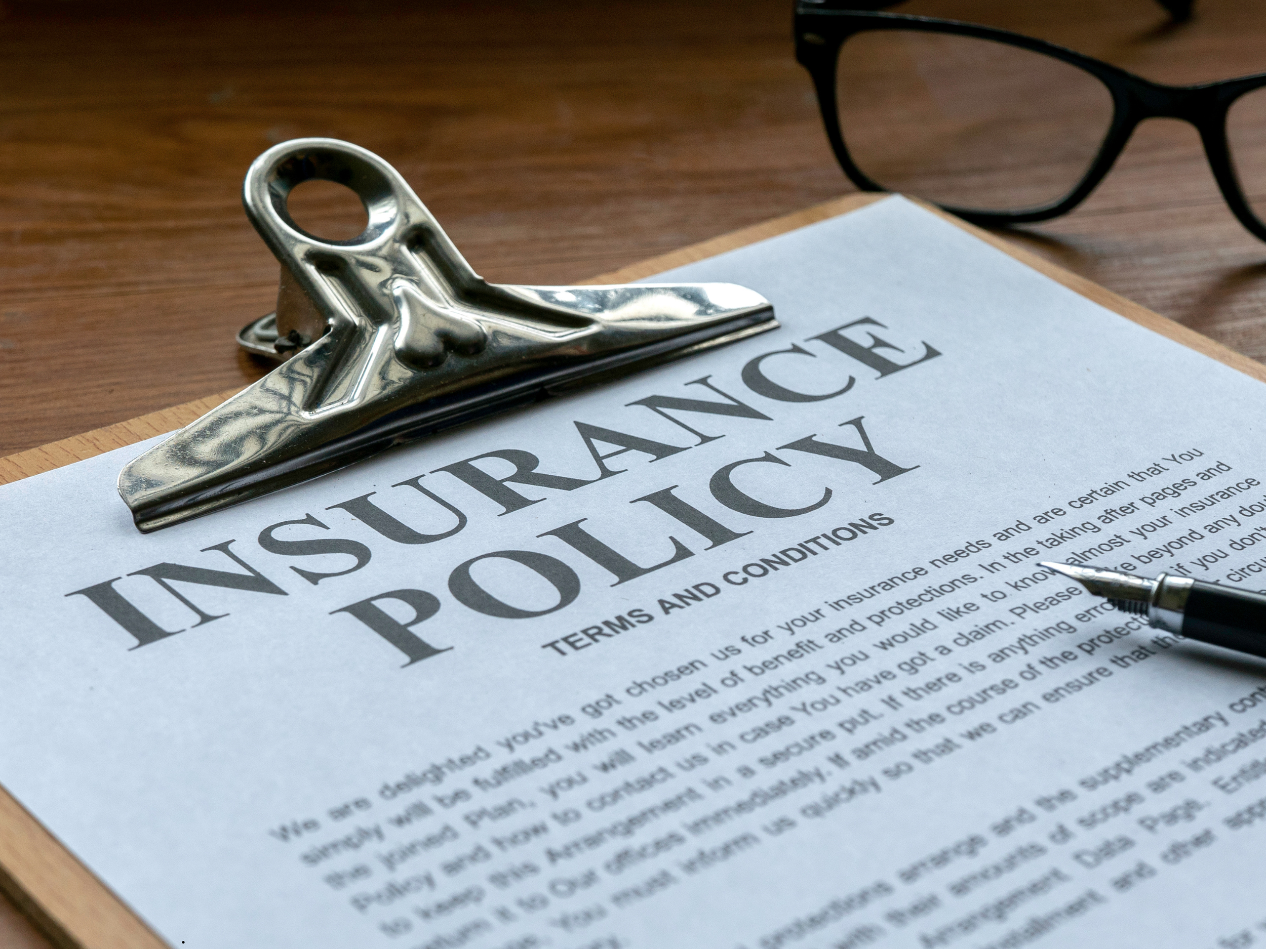 Hand holding a tablet with a pen, displaying the cover of the 'Lipedema Insurance Navigator' eBook. Package 2 includes the eBook and toolkit bundle, offering expert strategies to strengthen your insurance case for lipedema reduction surgery.