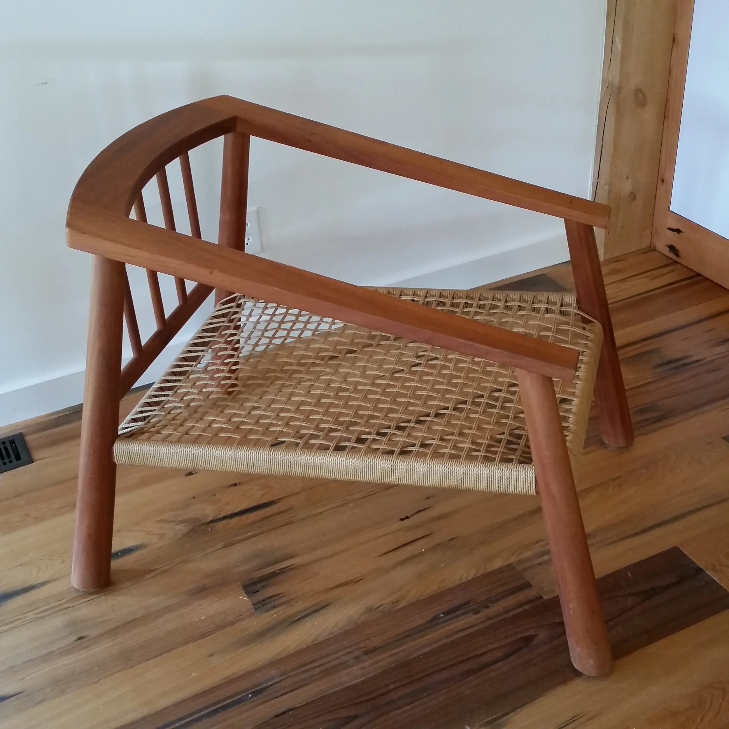 Solid African mahogany chair with tapered turned legs and web seat.