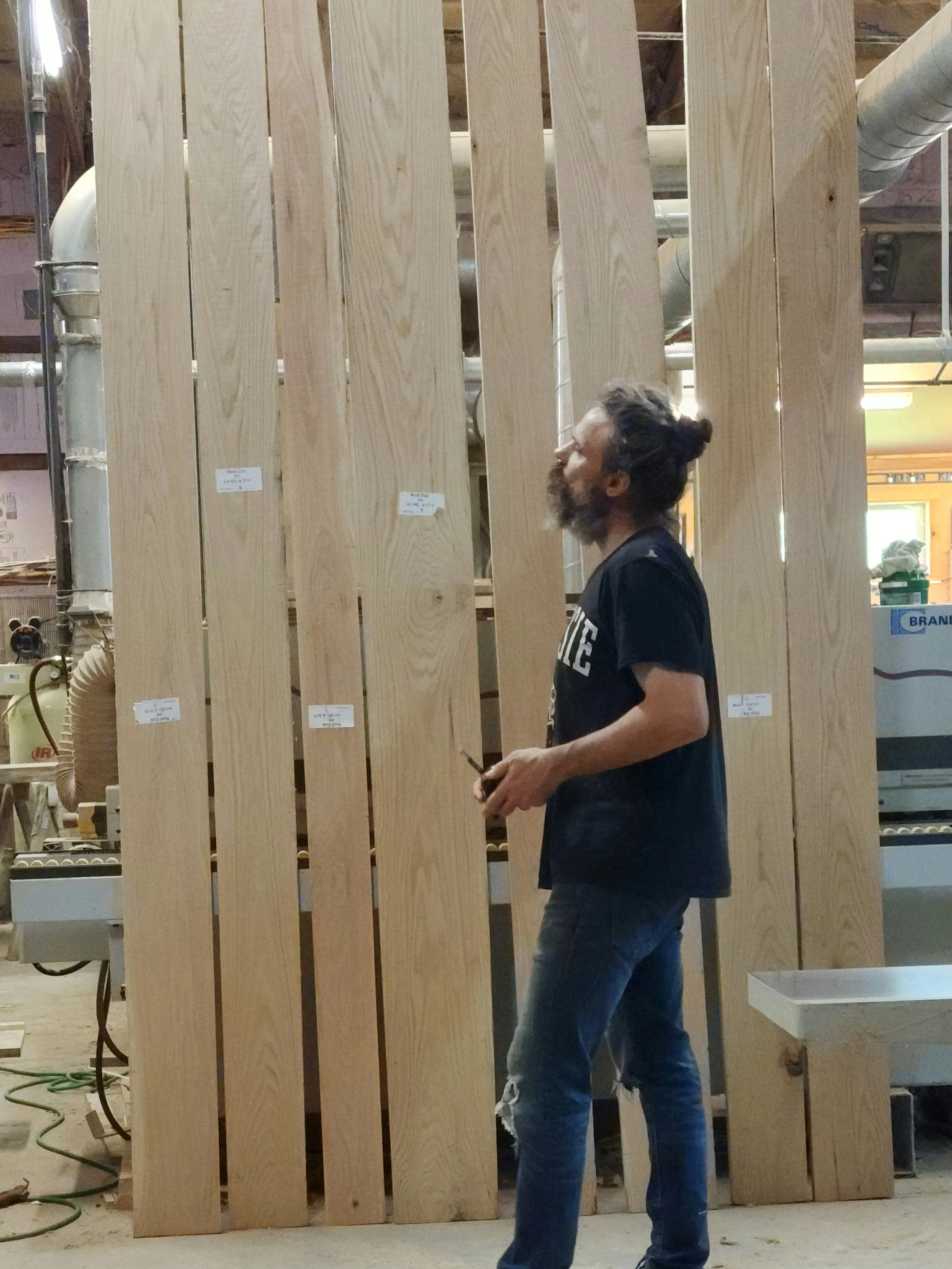 Furnituremaker selecting rough cut boards for custom commissioned furniture project