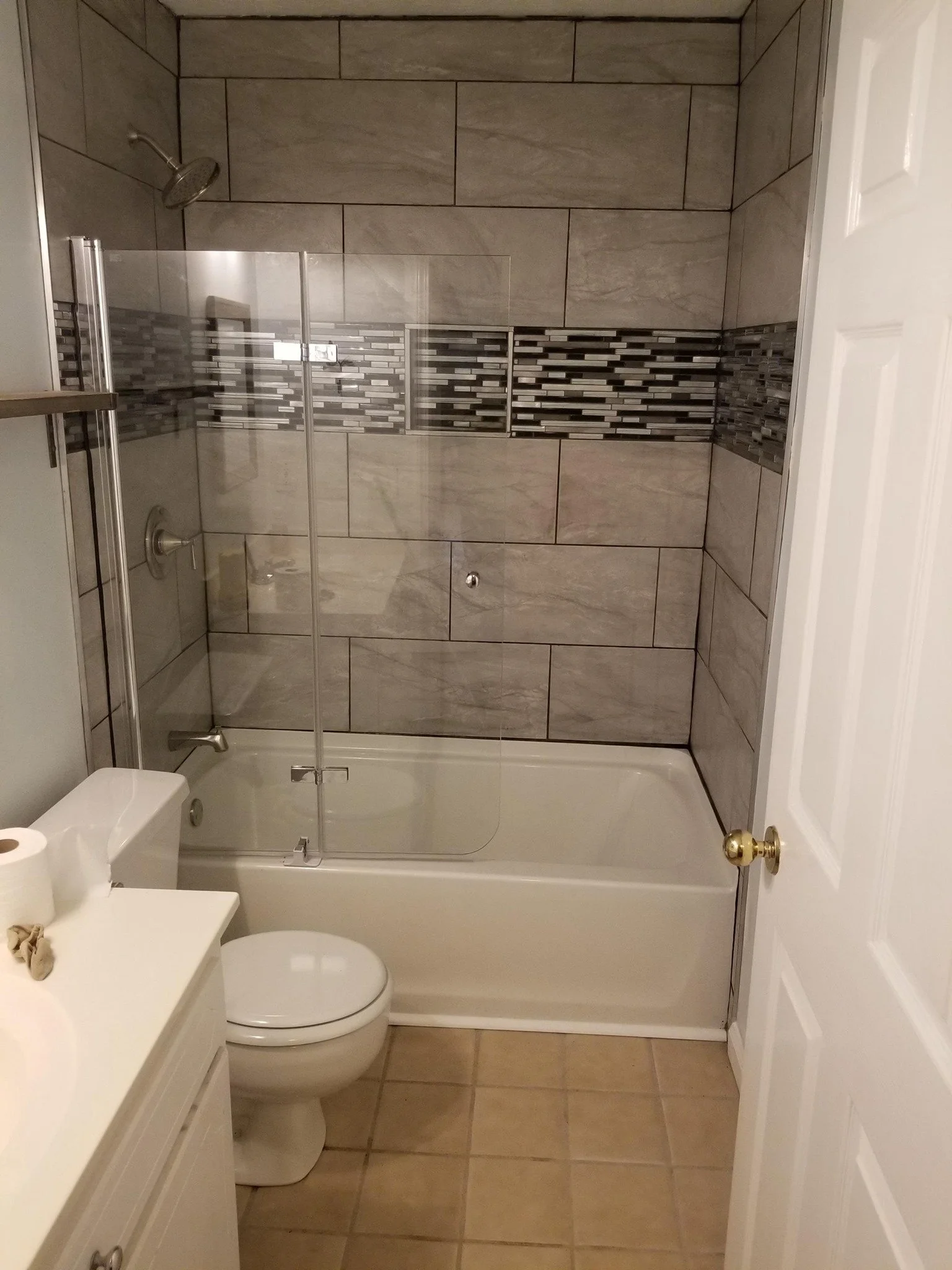 View from Doorwash of new tile shower build in a gray, silver, black color pallet.