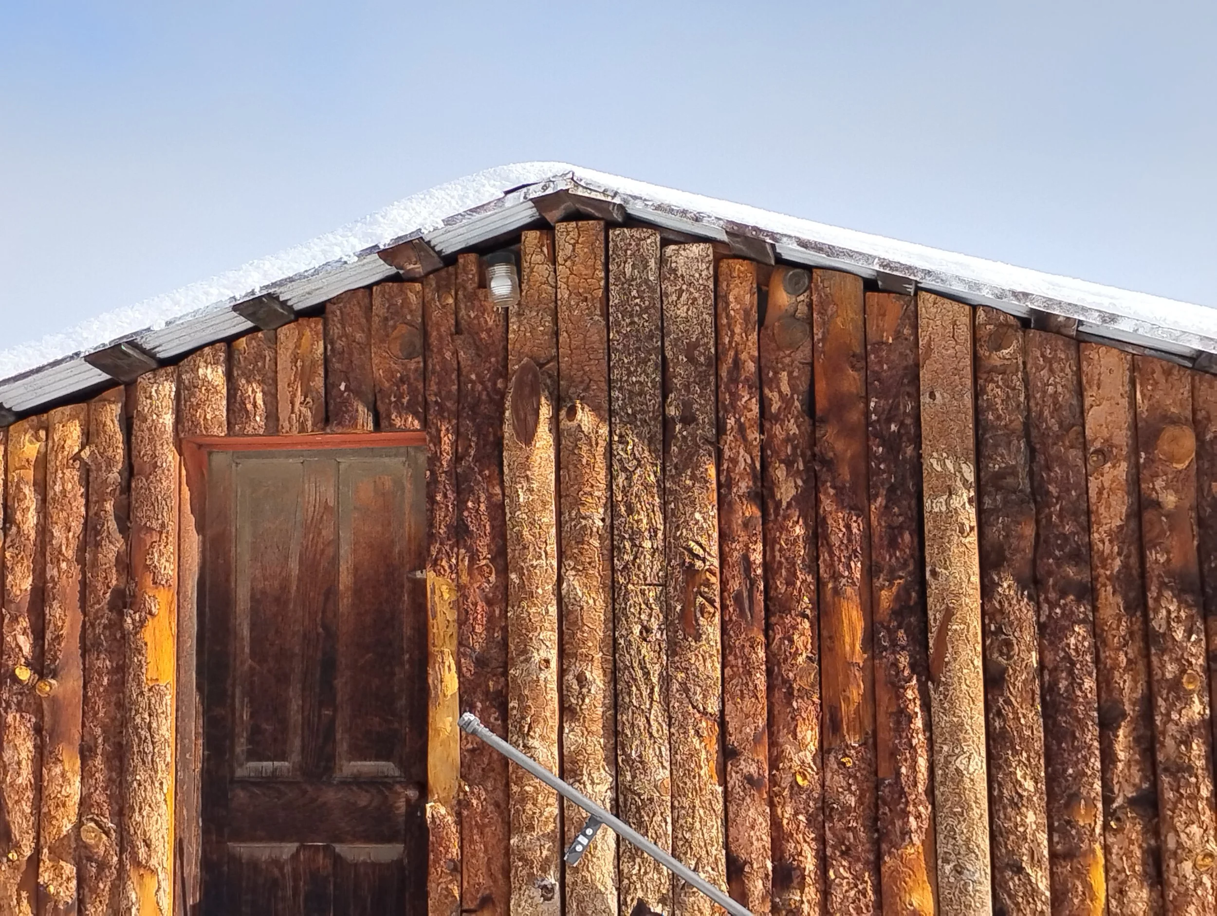 Snow covered aged wooden cabin, mushii kloth copyright 2025, Kloth Ltd