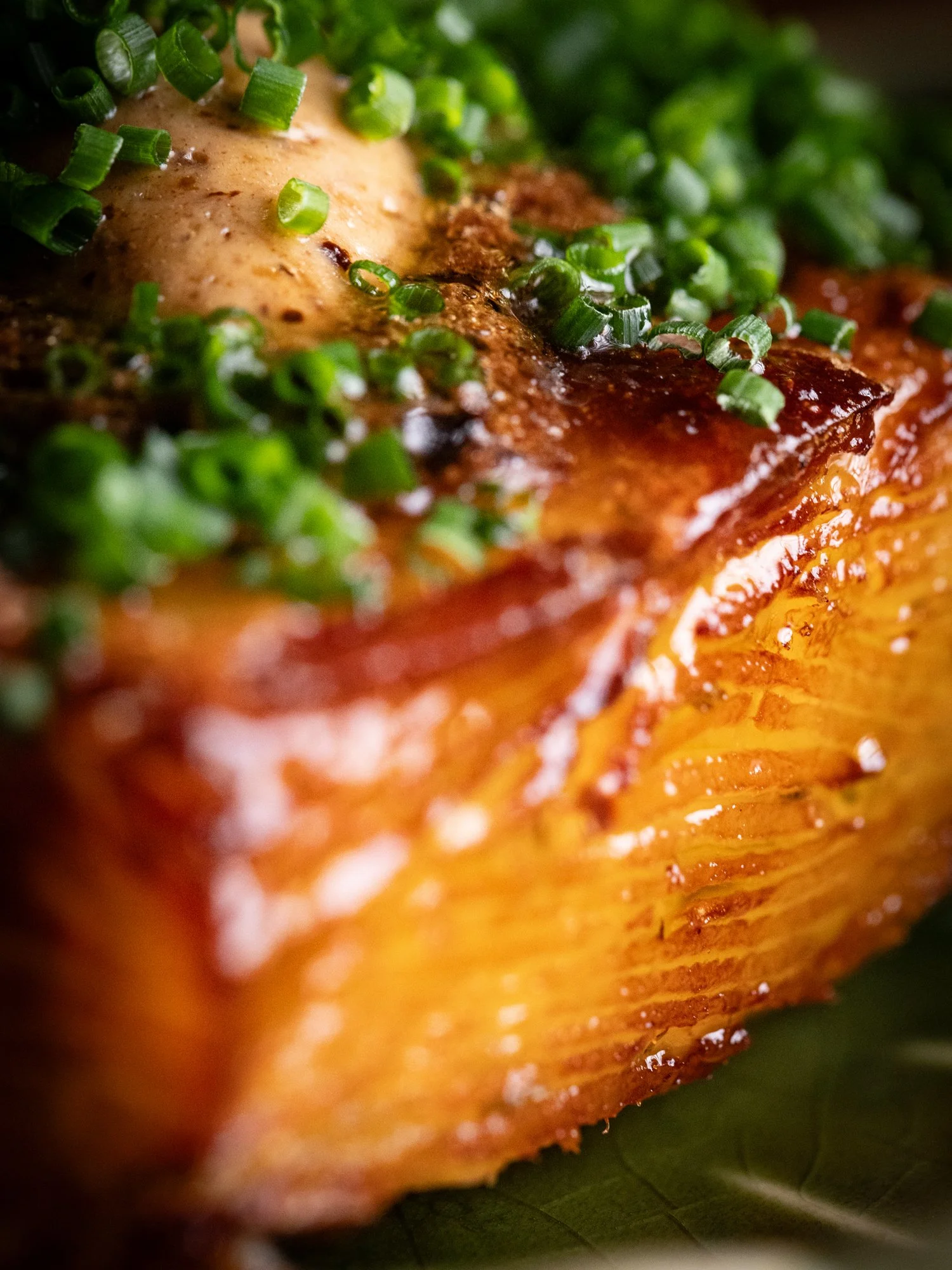 Doju Potato with black garlic butter and chopped chives, our signature side dish