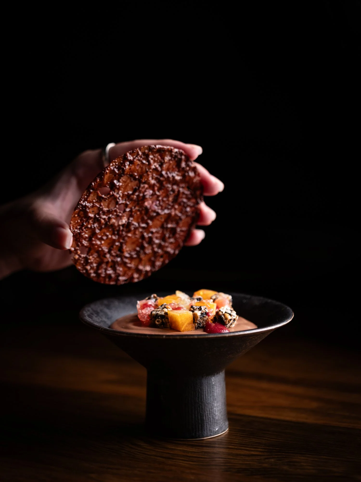 Chocolate mousse with sweet persimmon, green citrus, finger lime, bokbunja gel, sesame hangwa, hazelnut, and coffee crisp