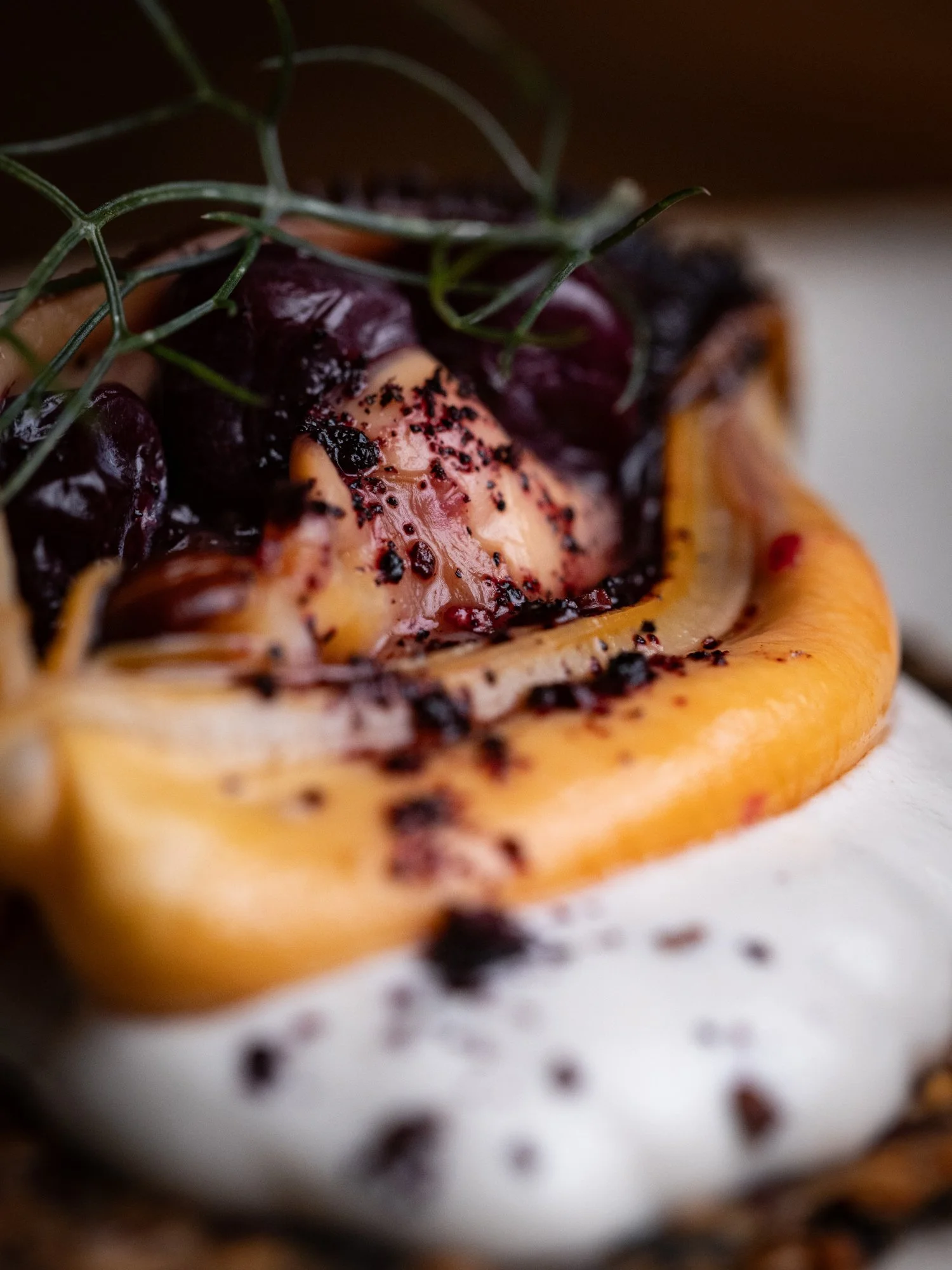 Smoked mussel on seeded cracker with cashew cream and fermented wild blueberry