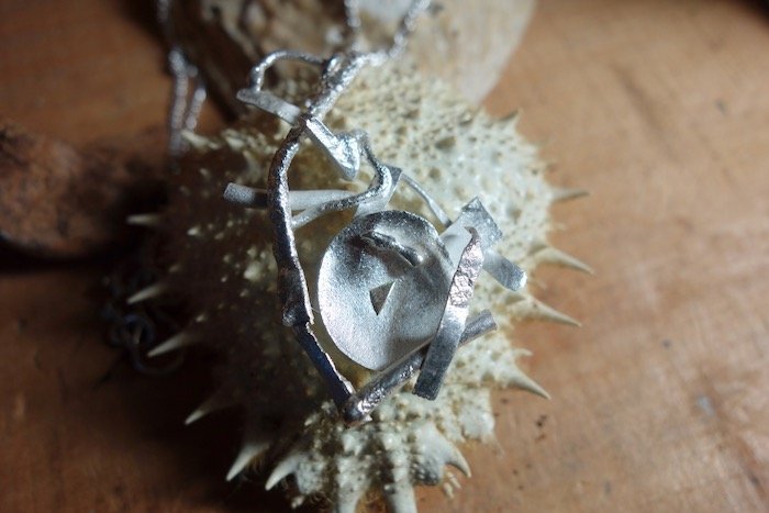 Detail of handmade abstract pendant in sterling silver
