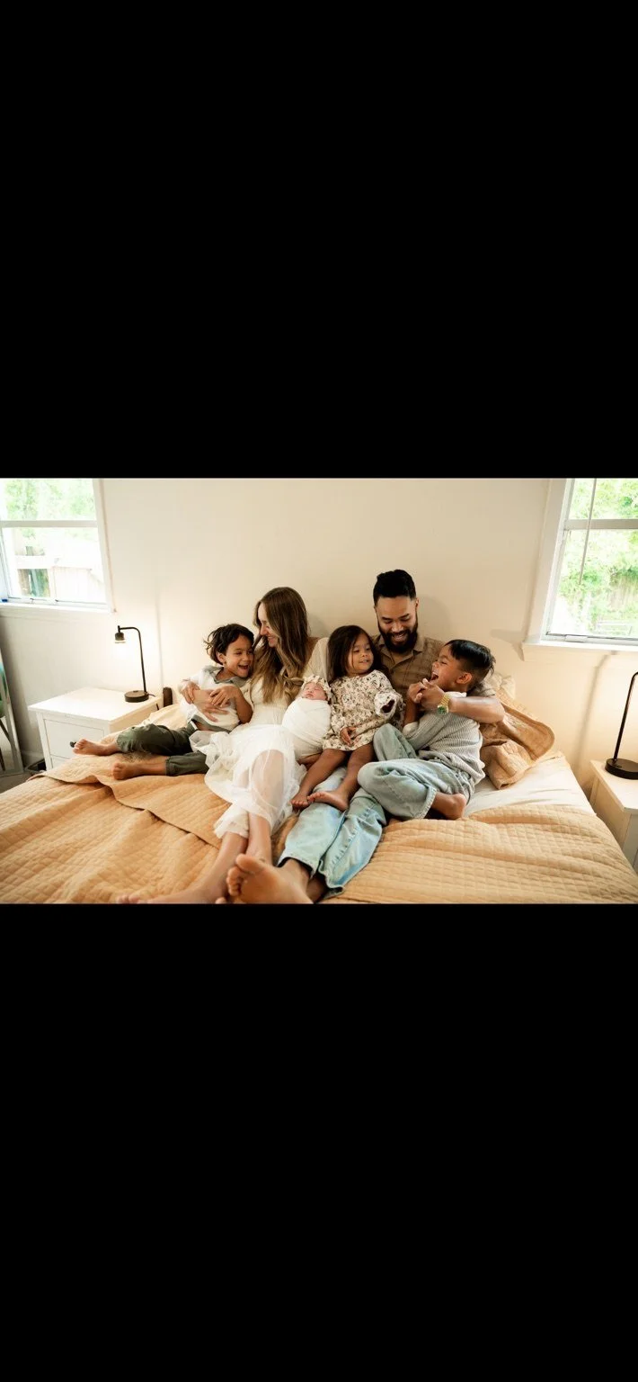 Owner of State Line Pressure Washing and his family of five laughing together at home.