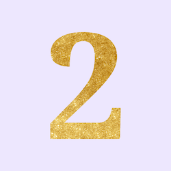 Golden glitter number 2 on a light purple background