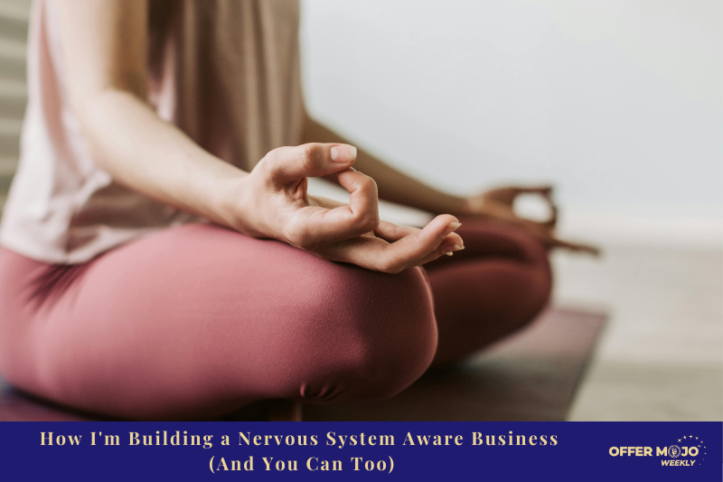 A person seated cross-legged on a yoga mat in a meditation pose, wearing soft pink clothing
