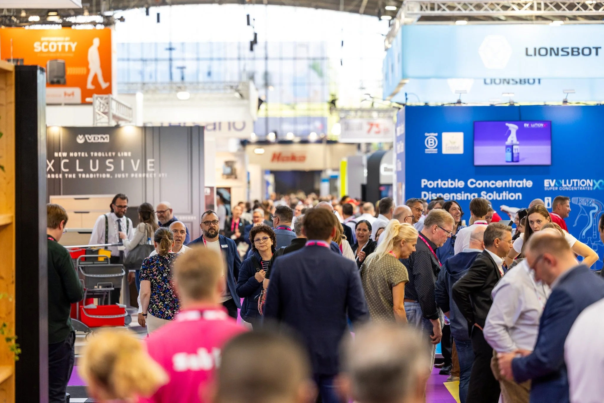 Interclean Amsterdam exhibition hall packed with facilities management and cleaning industry stands and visitors.