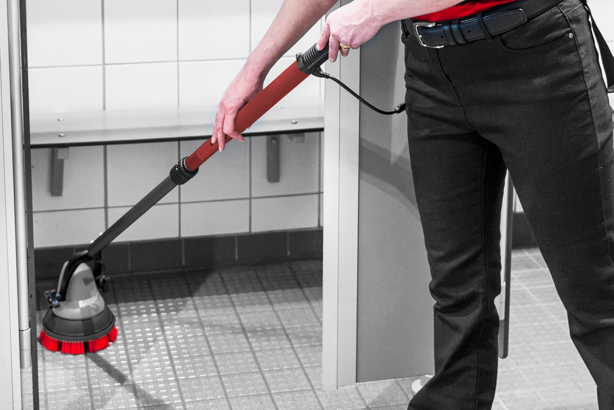 Close-up of the MotorScrubber M3 reaching under washroom fixtures and partitions to clean confined floor areas that are difficult to access with conventional cleaning equipment.