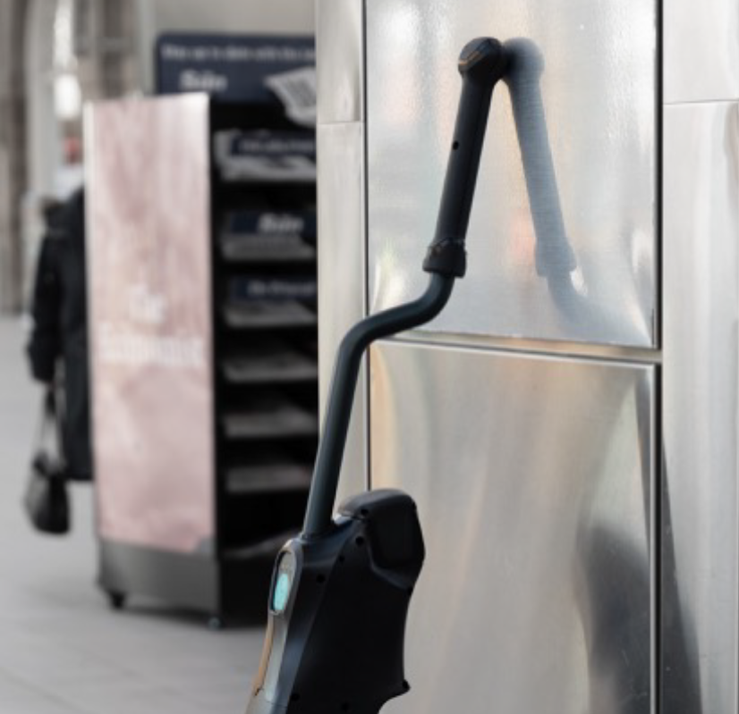 DRYFT leaning against a wall using the non-slip handle grip, showing quick wall-stand storage that keeps the machine secure and out of the way.