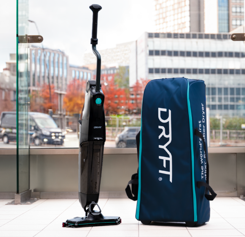 DRYFT scrubber dryer standing beside a protective DRYFT carry case, showing padded storage that keeps the system secure, organised, and ready to move between sites.