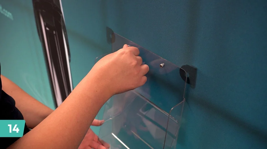 Attach the brochure holder within the mouth of the frame by placing it onto the graphic and securing the mount from behind.