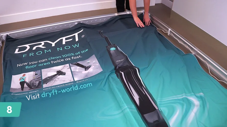 Place the graphic over the frame ensuring the holes align with the TV bracket.