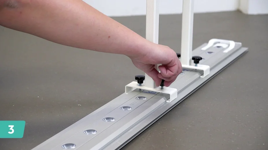 Slide on TV bracket to the ceiling piece, facing upwards.