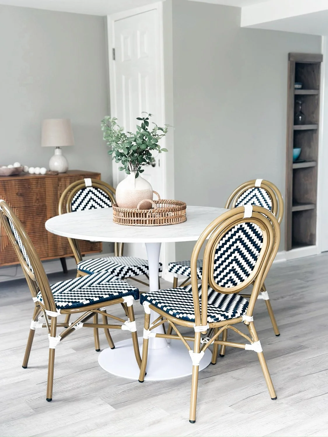 Round-white-table-with-gold-chairs-with-black-and-white-herringbone-pattern.jpg