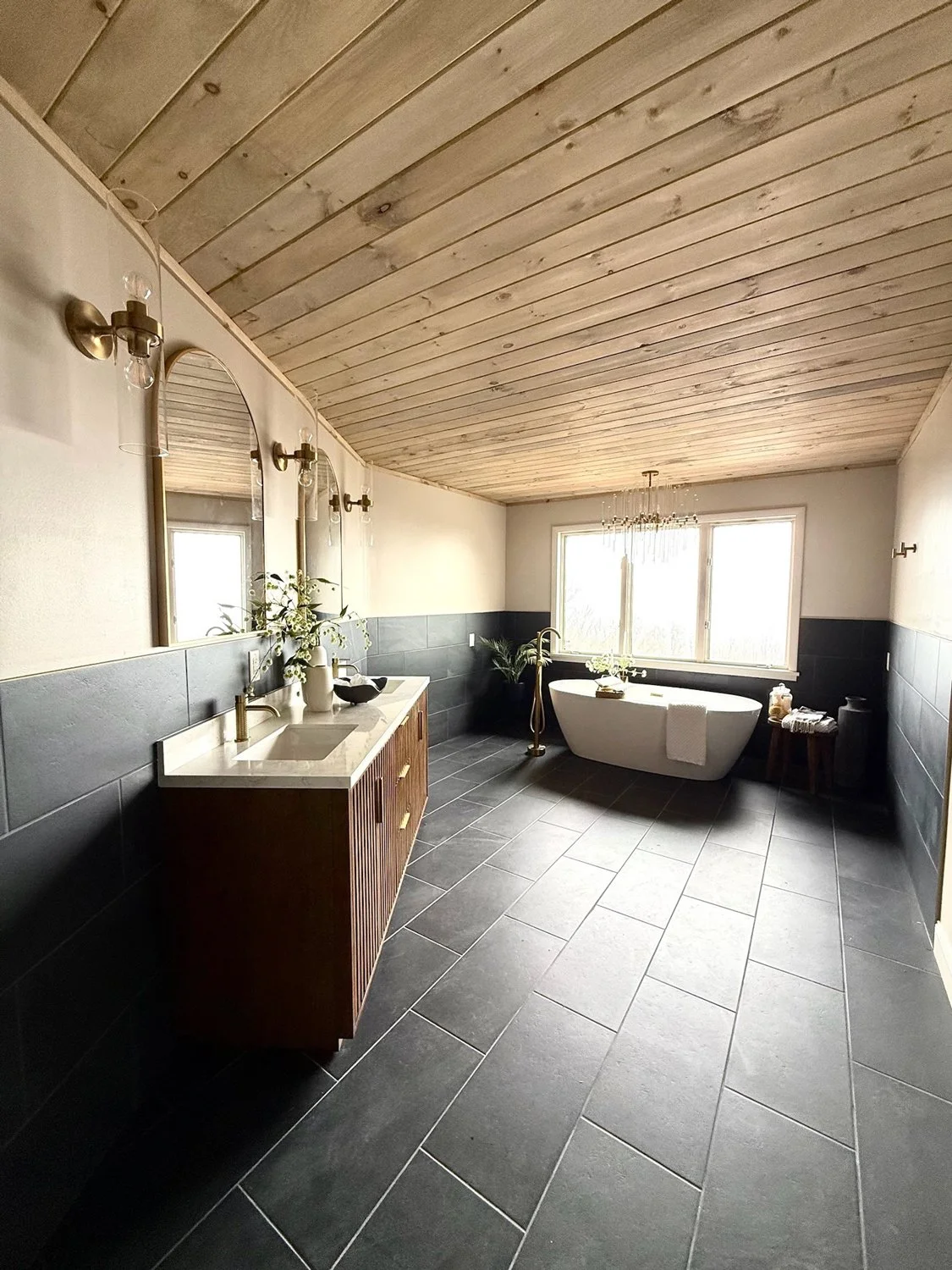 Luxe-bathroom-with-wooden-ceiling-and-black-tile-floor-with-soaking-tub-and-2-person-vanity.jpg