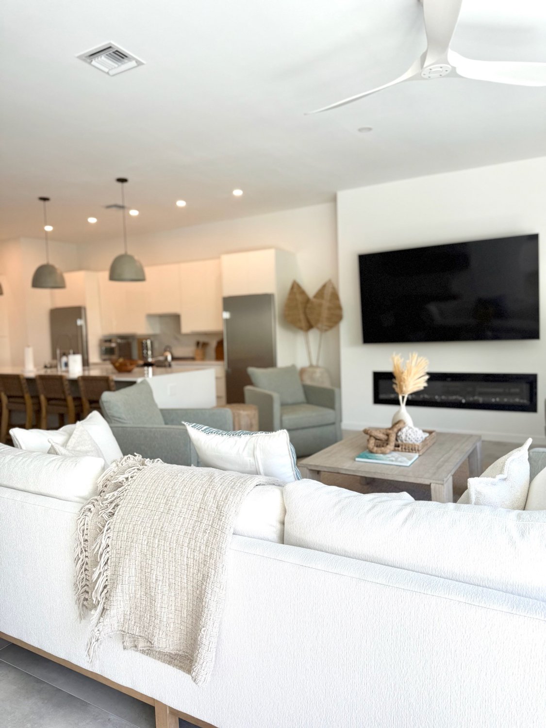 White-sectional-sofa-facing-tv-and-open-kitchen.jpg