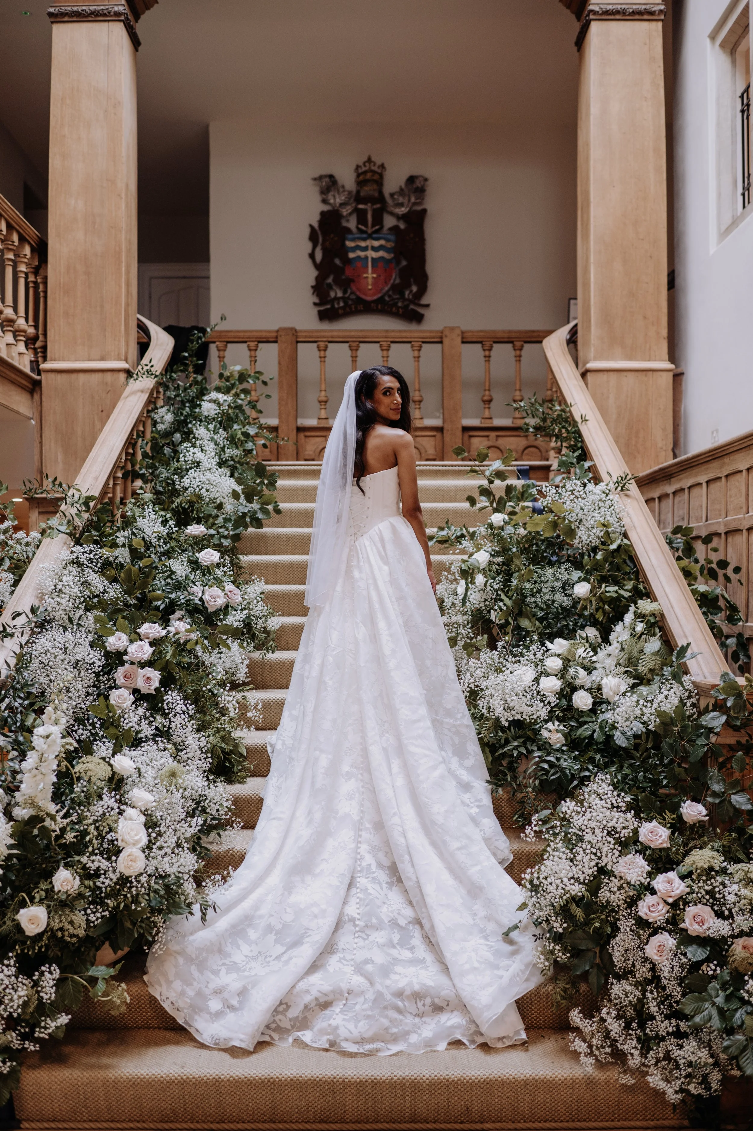 Wedding floral staircase installation at Farleigh House, Bath, designed by Florista, a Somerset based wedding florist specialising in bespoke wedding flowers.