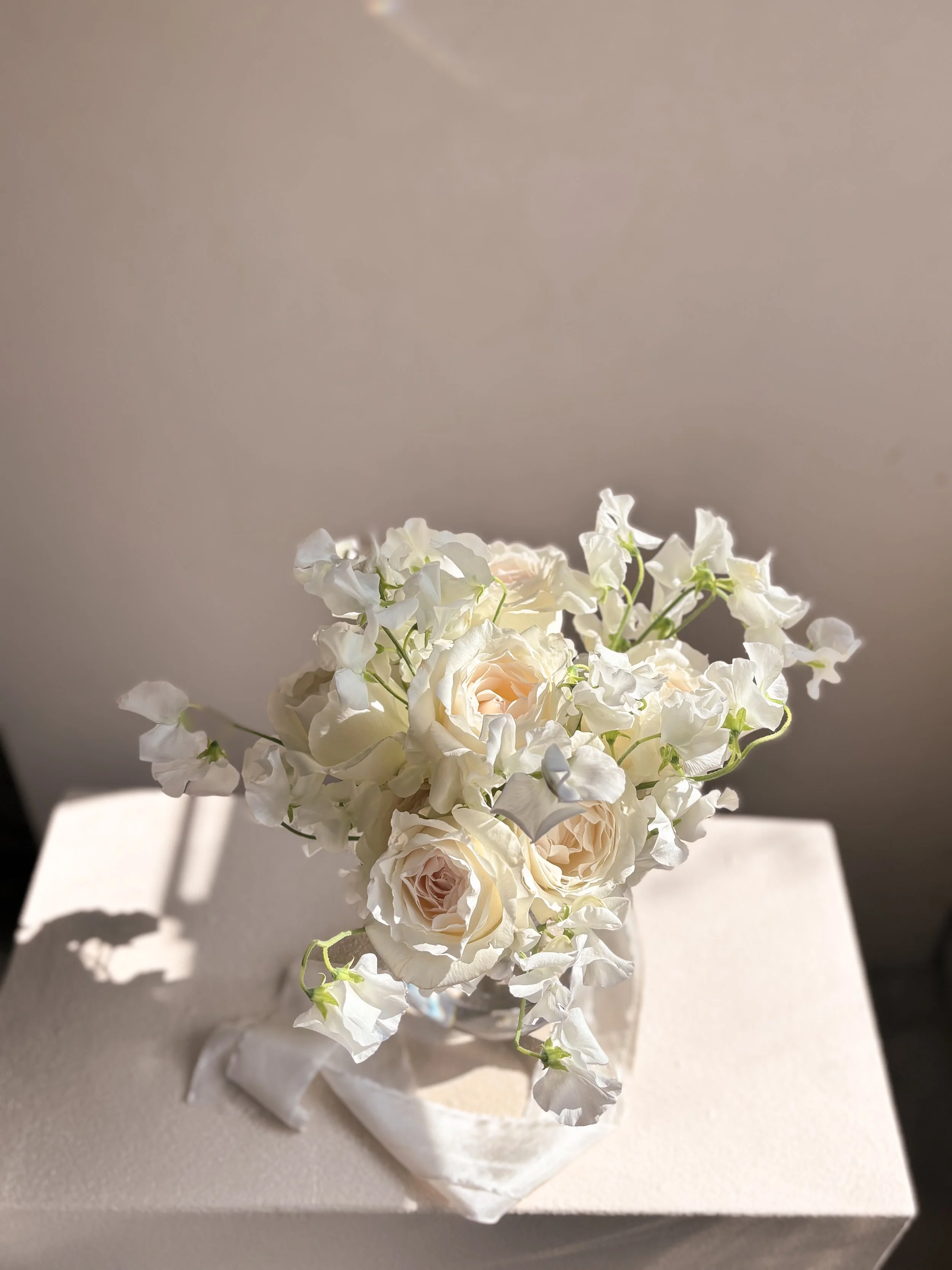 Summer bridal bouquet of sweet peas and David Austin garden roses at The Bath Spa Hotel, Bath.