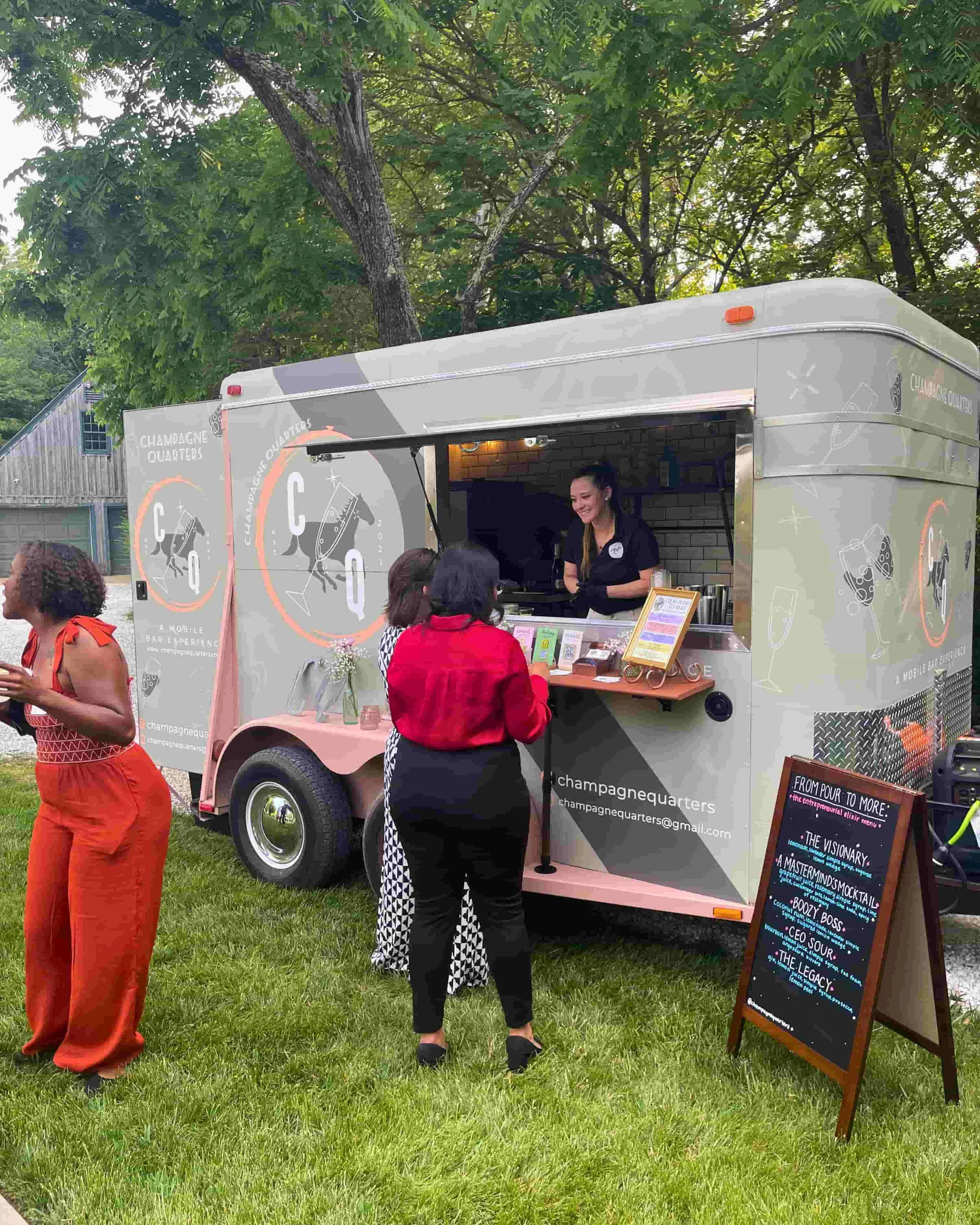 Champagne Quarters horse trailer mobile bar serving cocktails to corporate event clients.