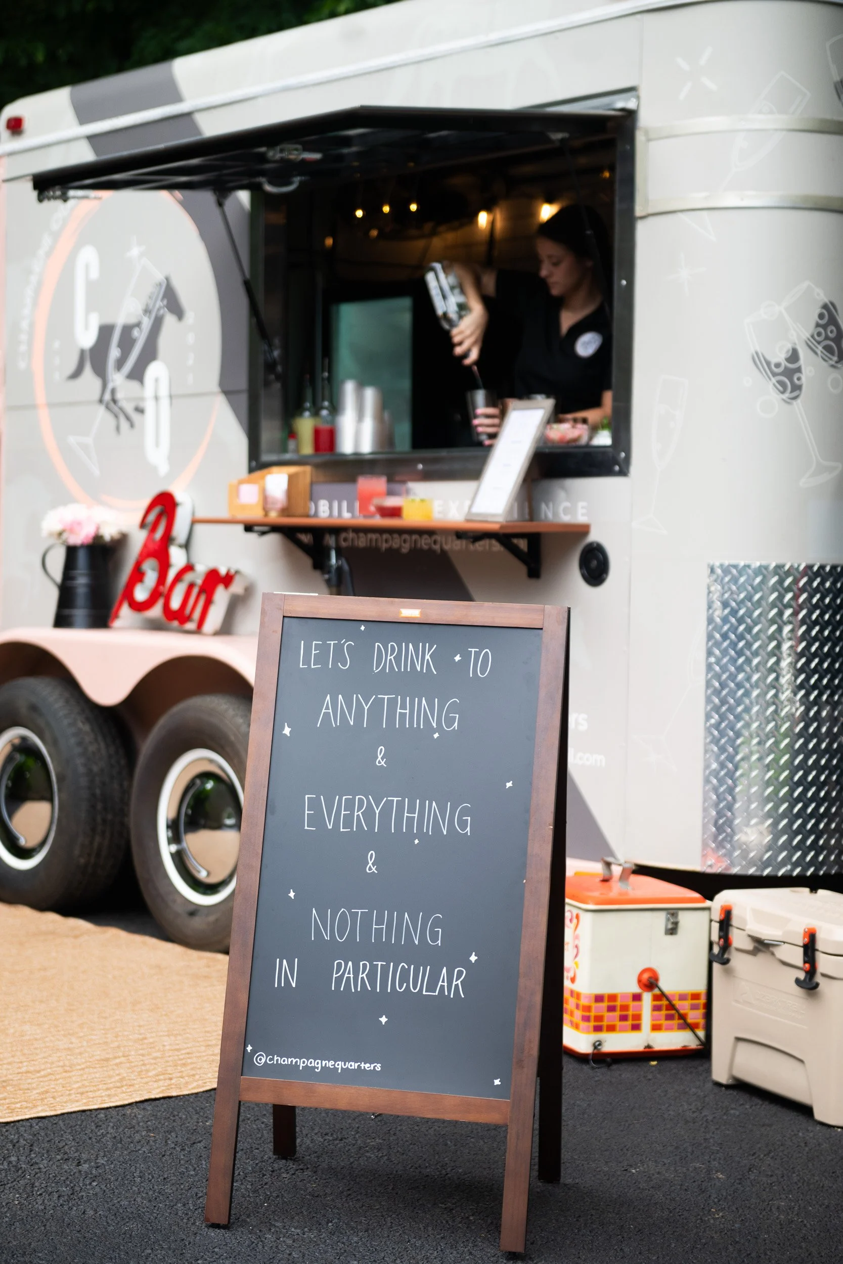 Champagne Quarters Mobile Bar trailer and A frame sign at an event.