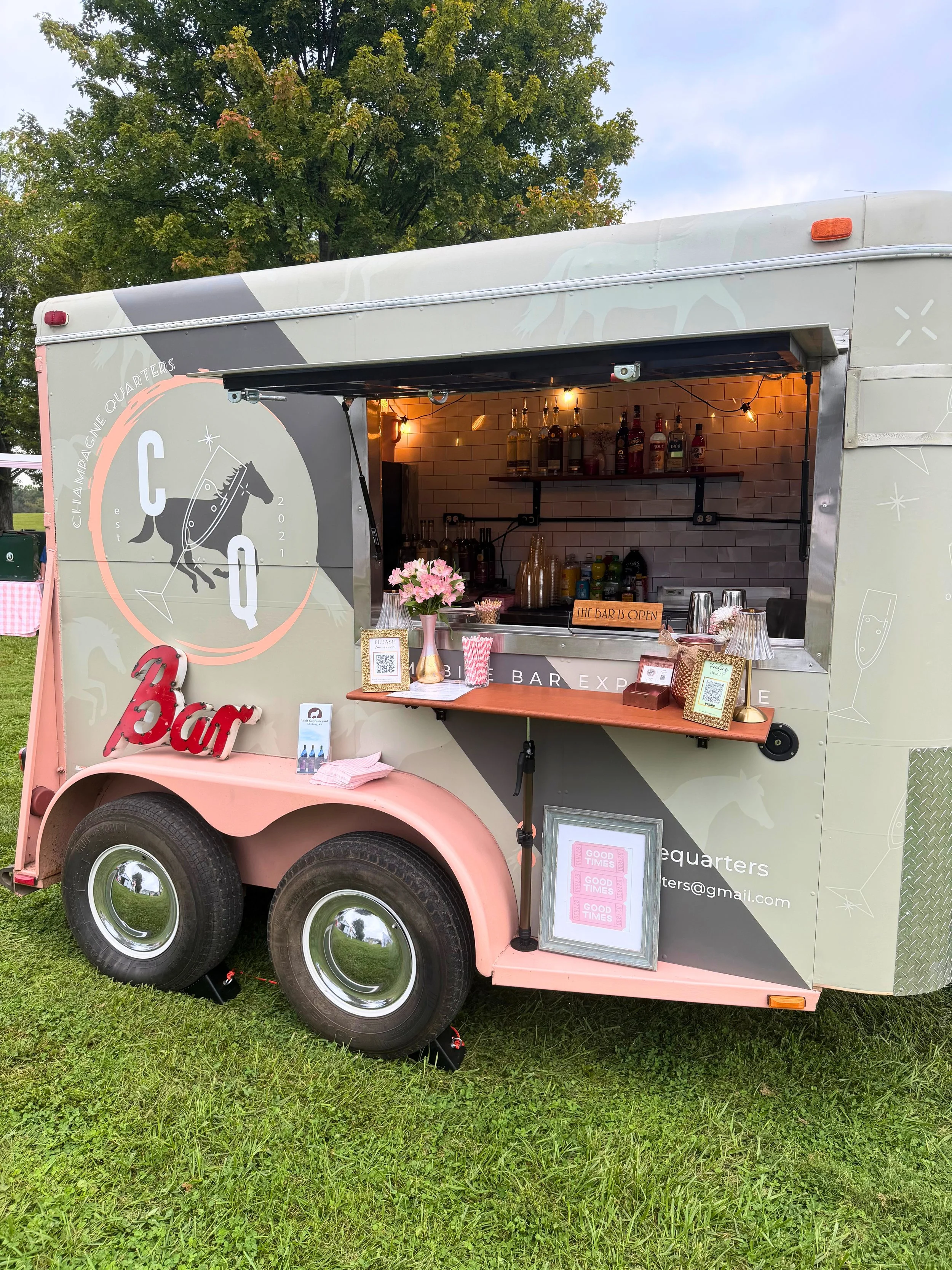 Horse trailer bar setup at a couple's pink & white picnic for a non-profit event in Middleburg, VA. Maryland mobile bar services.