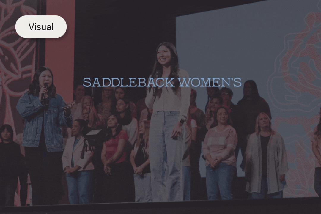 Group of women on stage at an event labeled 'Saddleback Women's Gathering,' with some holding microphones and a large screen in the background.