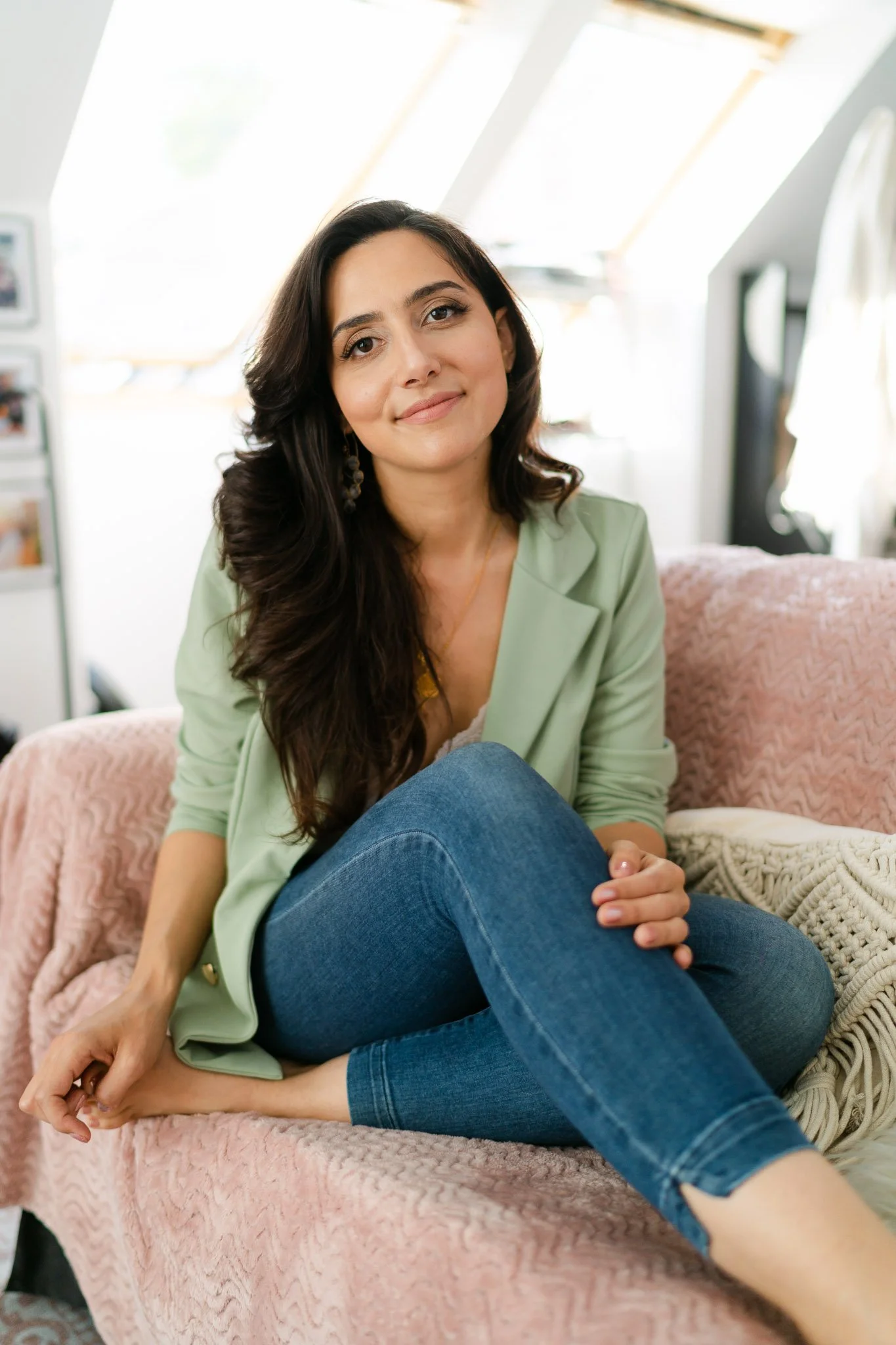 Medical intuitive photographed  sitting on a coach in her office