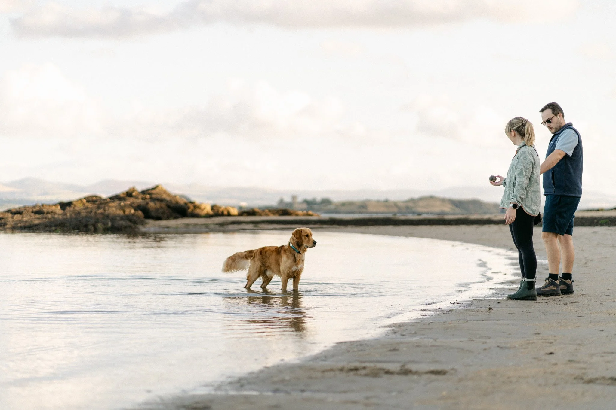 Family with golden retriever on the beach in Fife, Scotland
