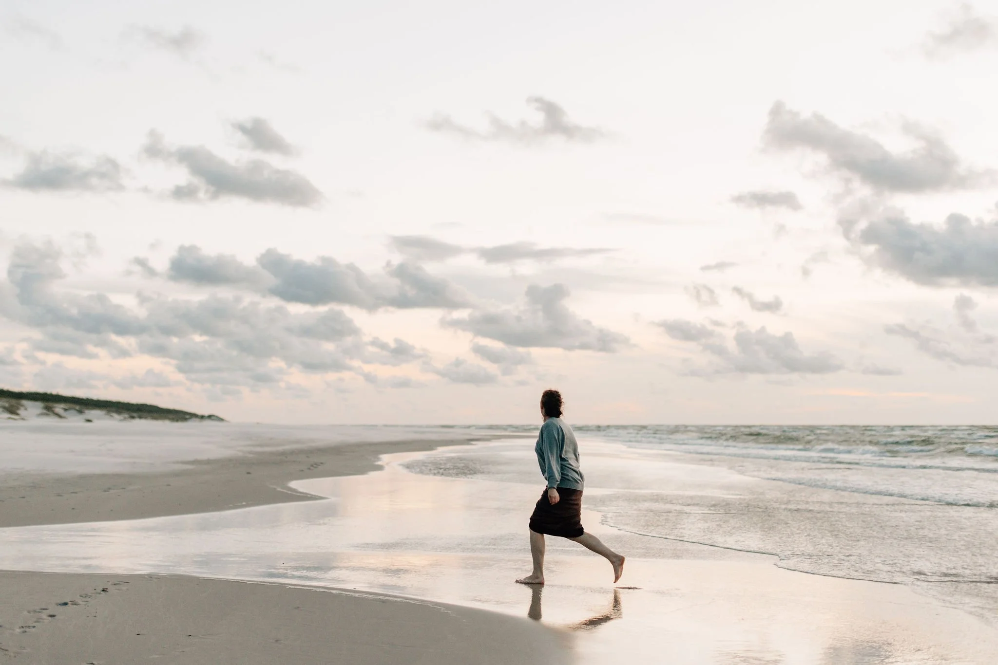 female photographer on the beach at sunset
