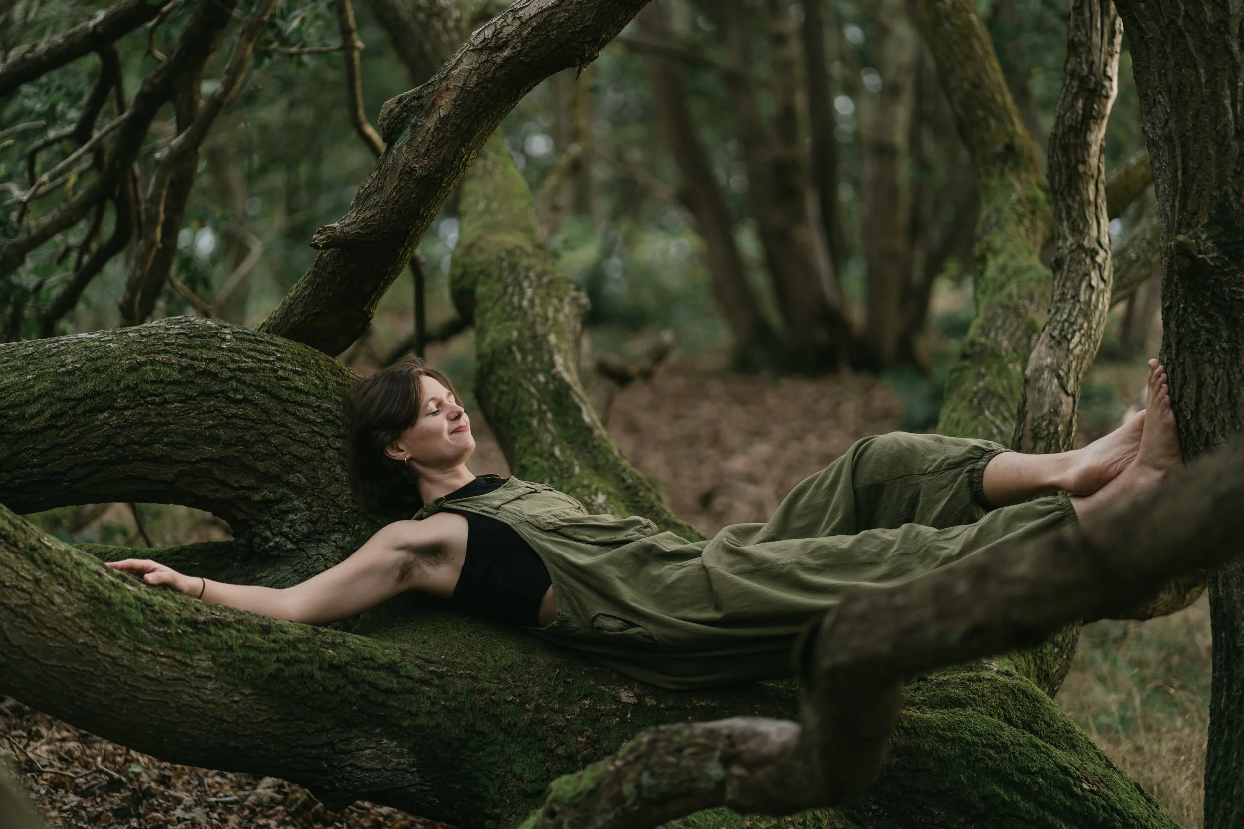 young woman resting on a tree in fife scotland