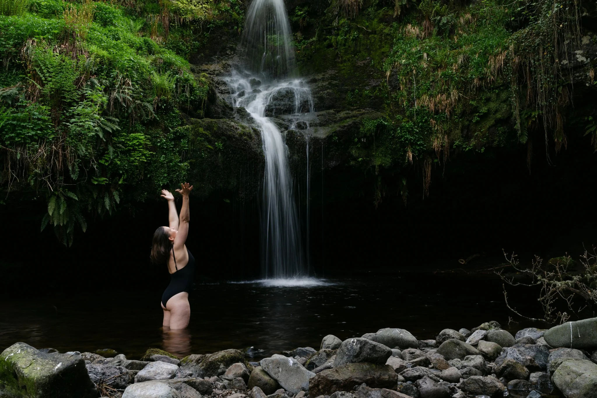 Feminine portrait in nature in Scotland, near waterfall