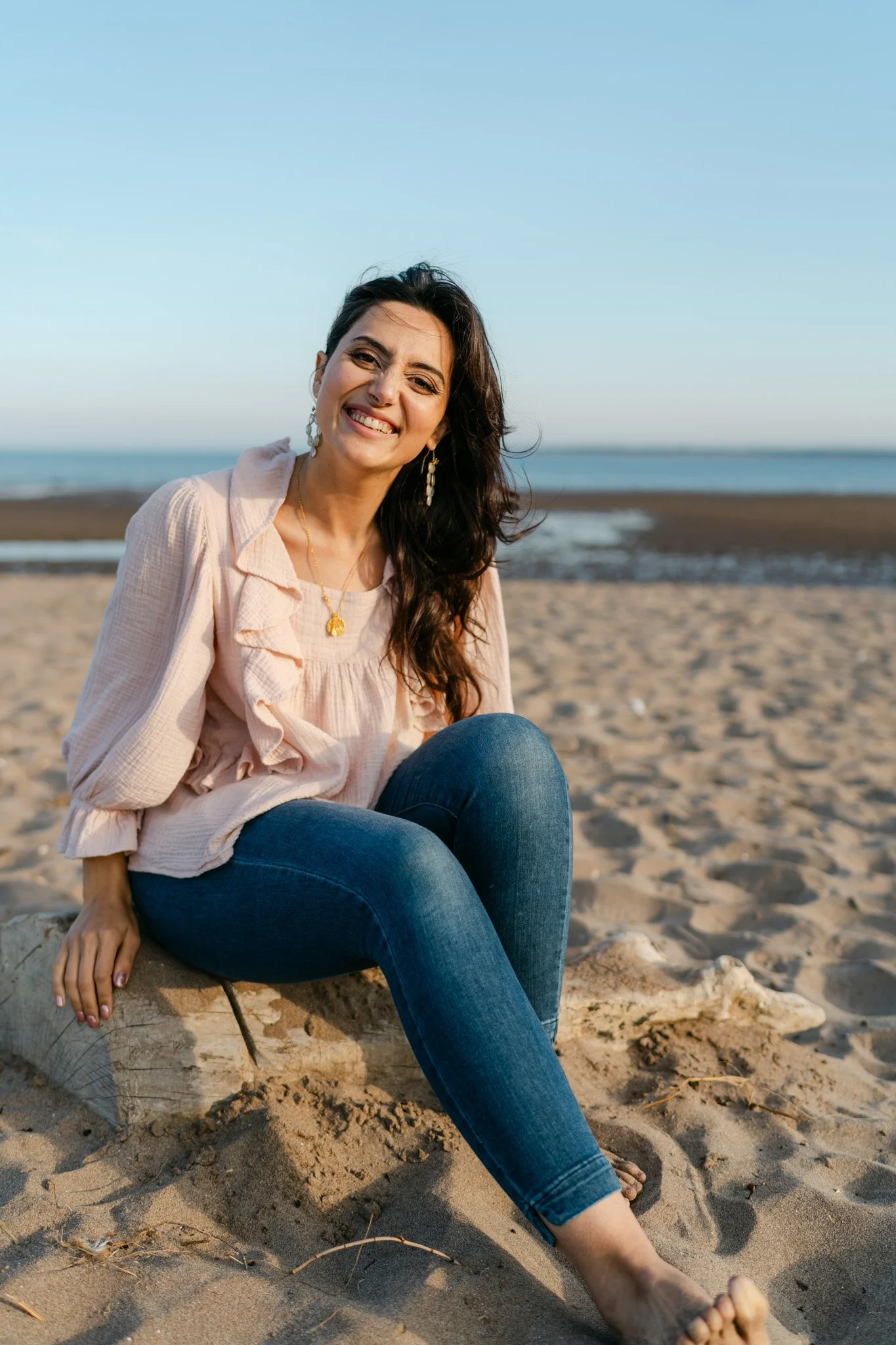 Medical intuitive photographed sitting on the beach at sunset